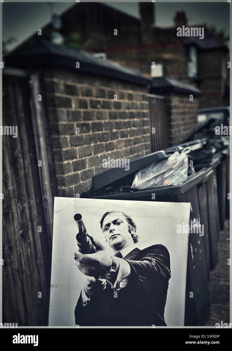 Portrait of Michael Caine left by the bins on the mean streets of East Finchley Stock Photo