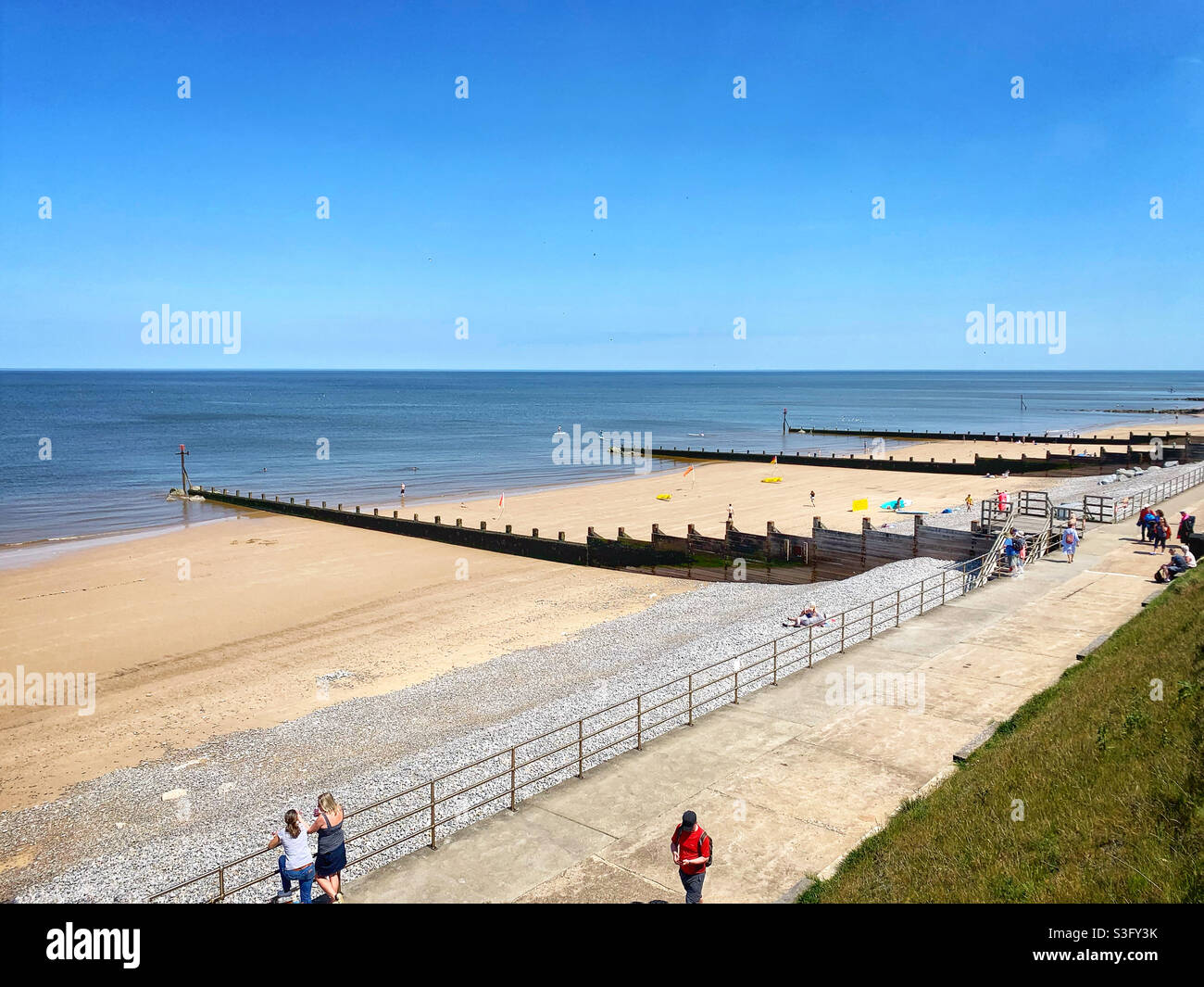 COVID 19. Staycation this year, chill out at the seaside. Big blue sky, Sheringham, Norfolk UK - Smartphone Captured Stock Image
