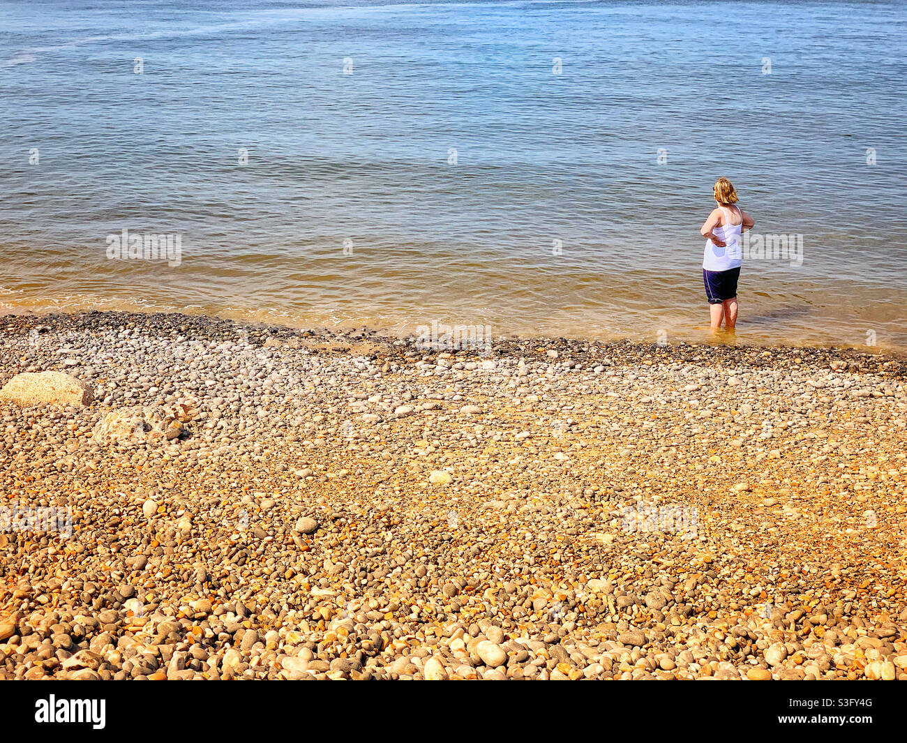 Lady enjoying a paddle in the sea, summer beach holiday Sheringham Norfolk UK. - Smartphone Captured Stock Image