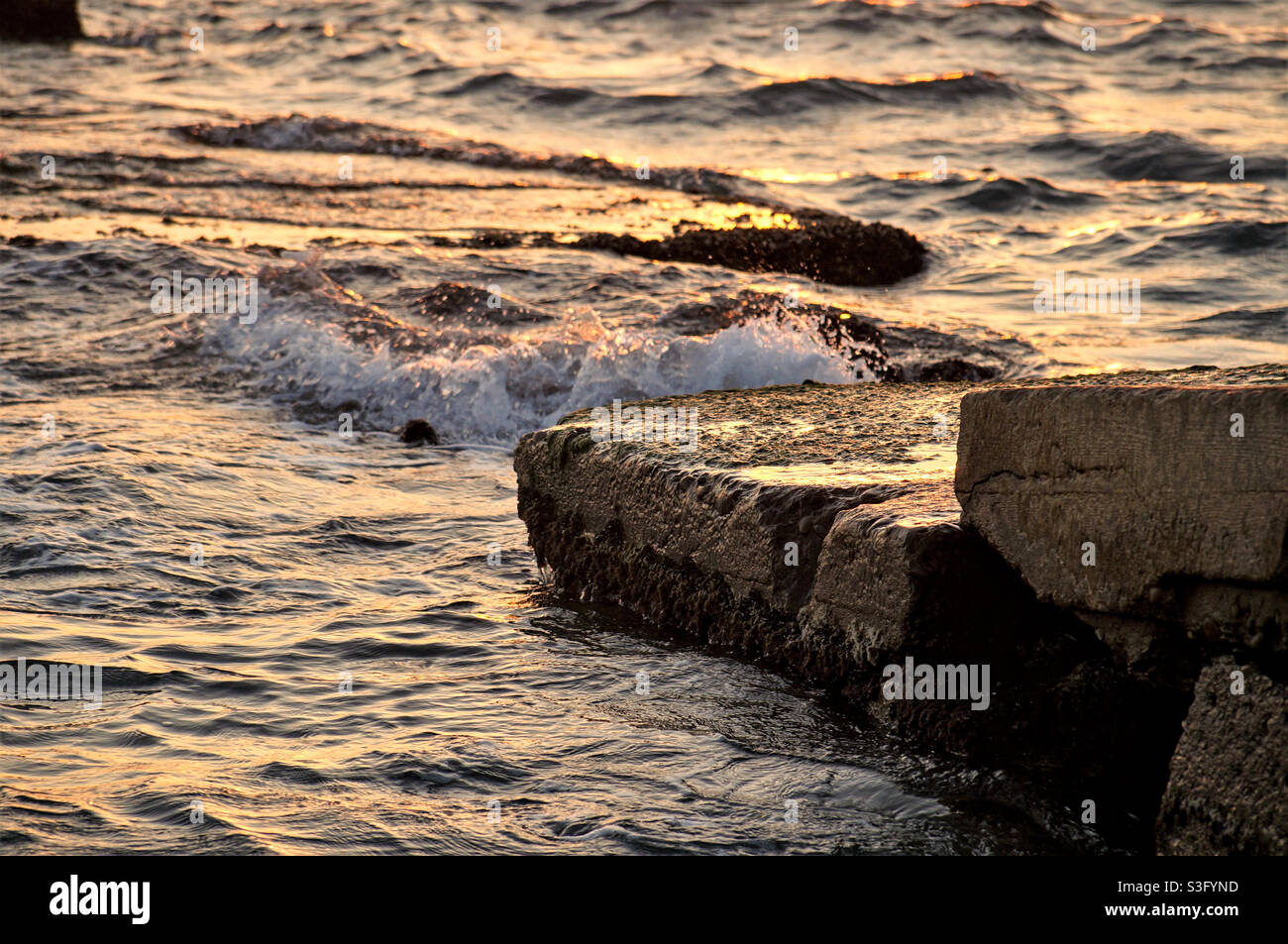 sea waves running on stone slabs - Smartphone Captured Stock Image