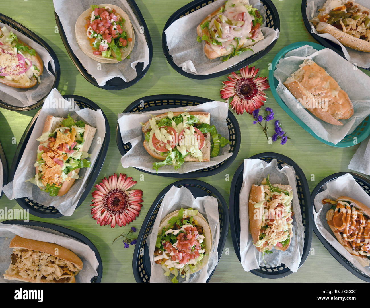 Food, ready to eat heroes, hoagies, subs top view on pale green table top abundance - Smartphone Captured Stock Image