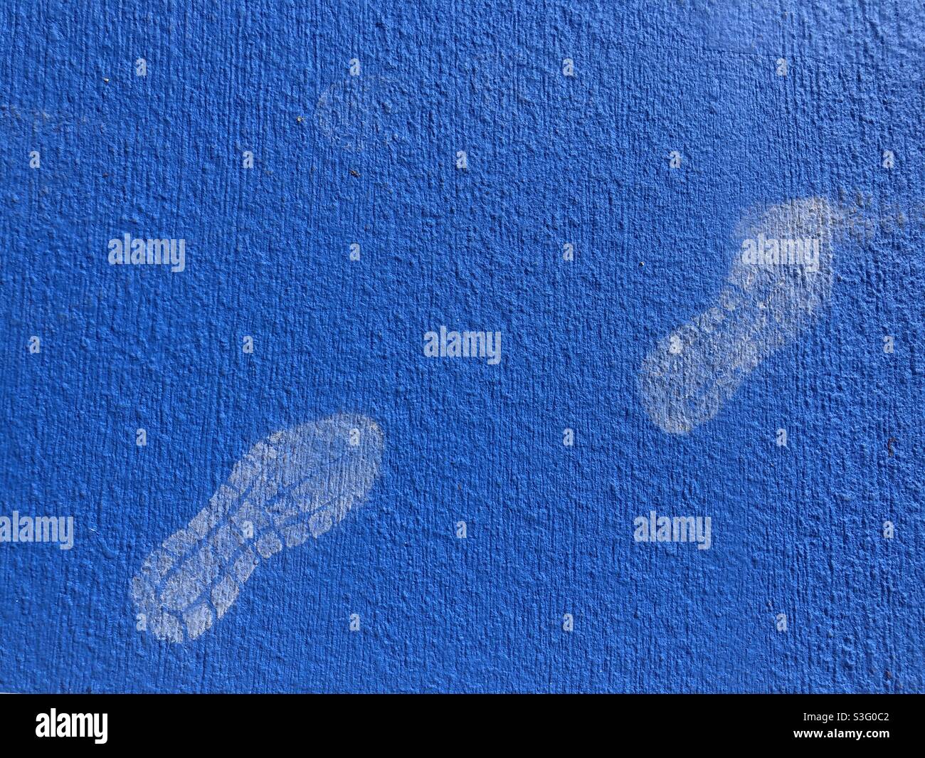 Footprints on blue painted floor - Smartphone Captured Stock Image