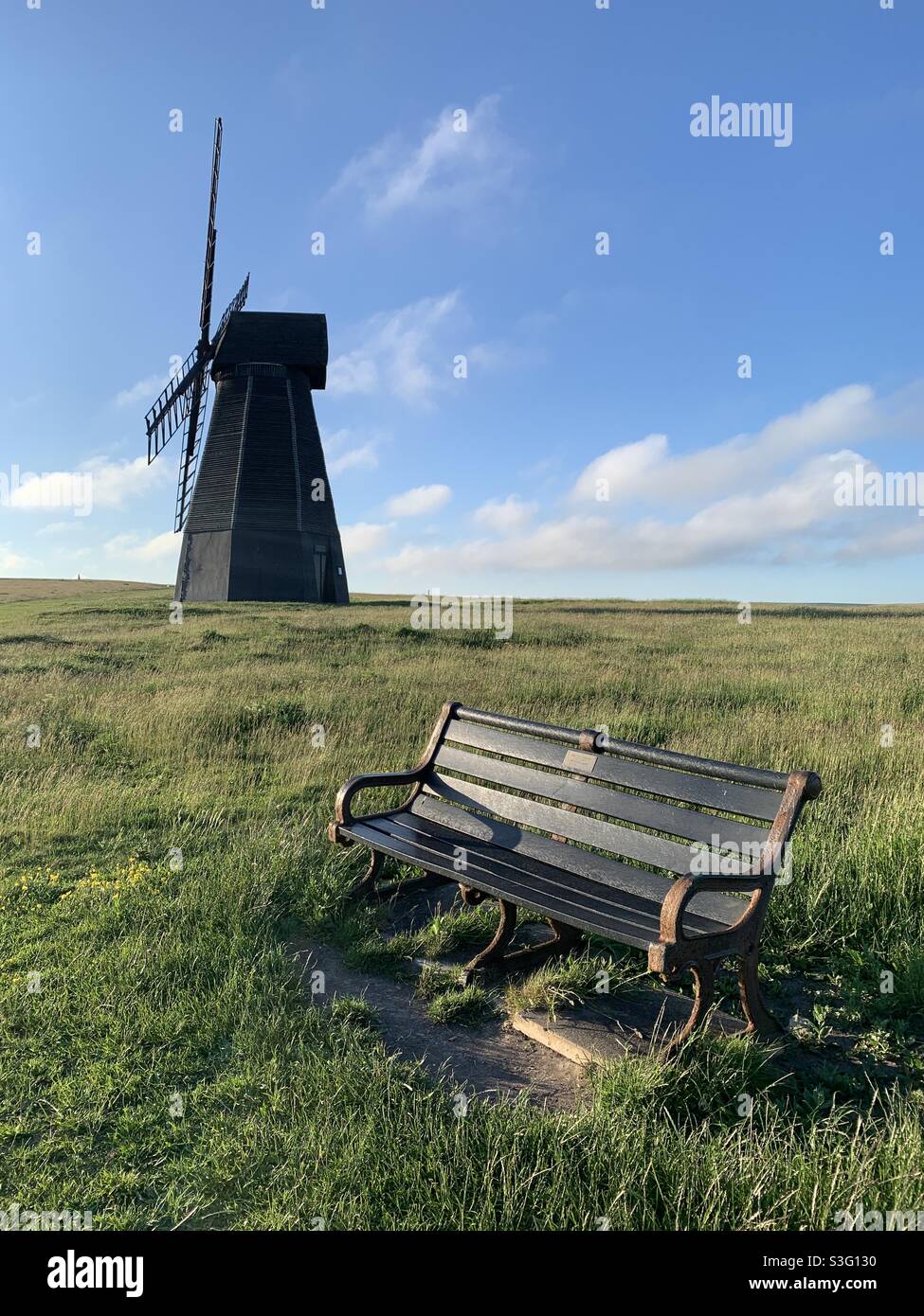 Rottingdean windmill and bench on a sunny day Stock Photo