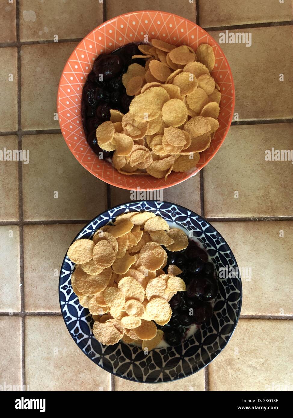 Two bowls of cornflakes with yogurt and cherries, 2021 - Smartphone Captured Stock Image