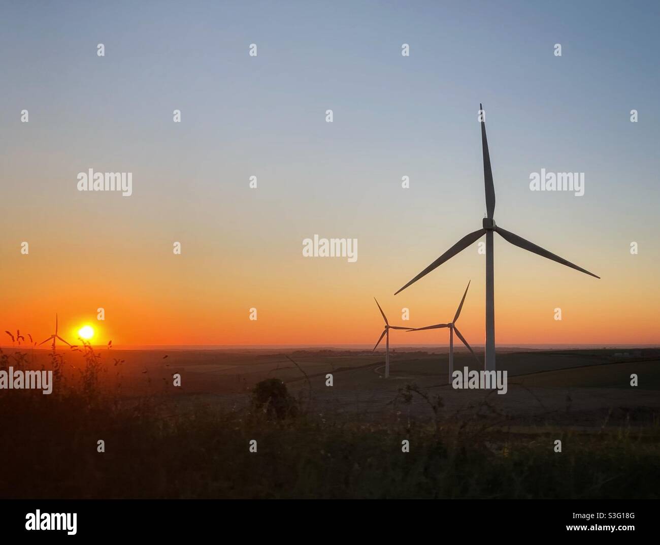 Renewable Energy - Cornwall Wind Turbines flowing in the sunset. - Smartphone Captured Stock Image