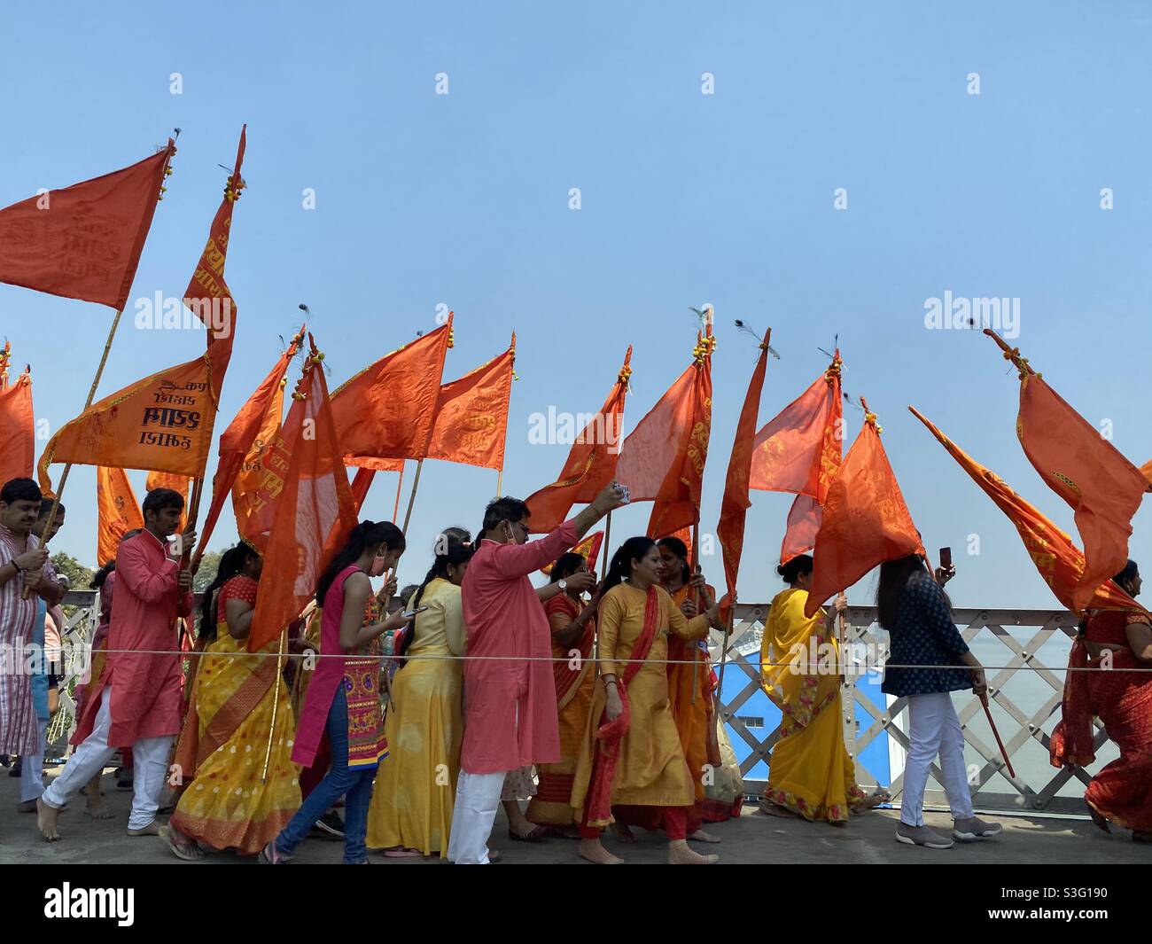 People walking together with red coloured flag - Smartphone Captured Stock Image