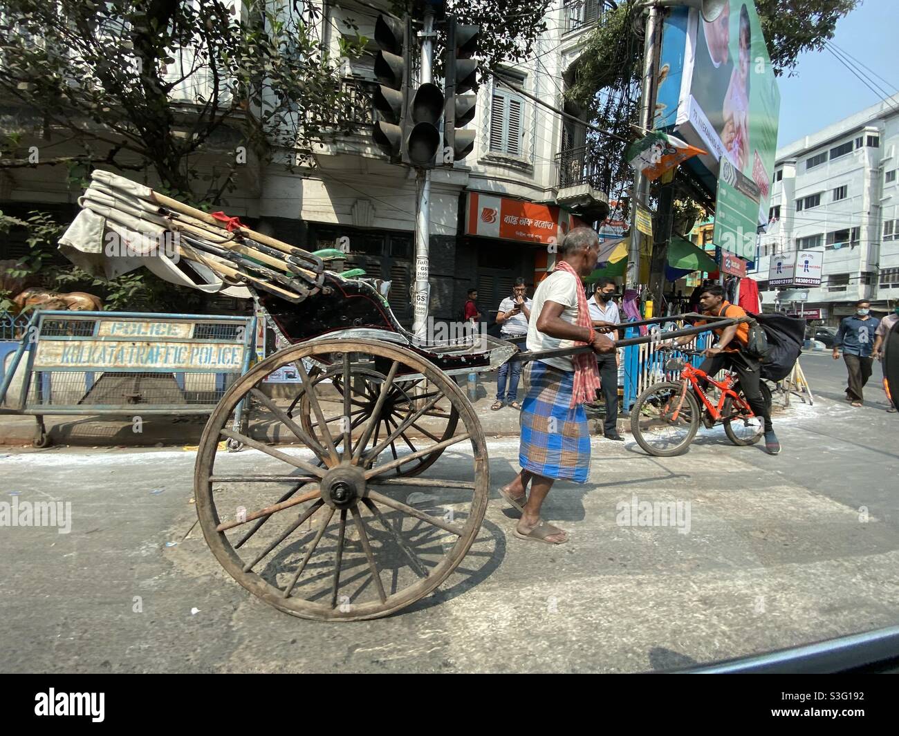 Hand pulled rickshaw puller in the road of Kolkata city - Smartphone Captured Stock Image
