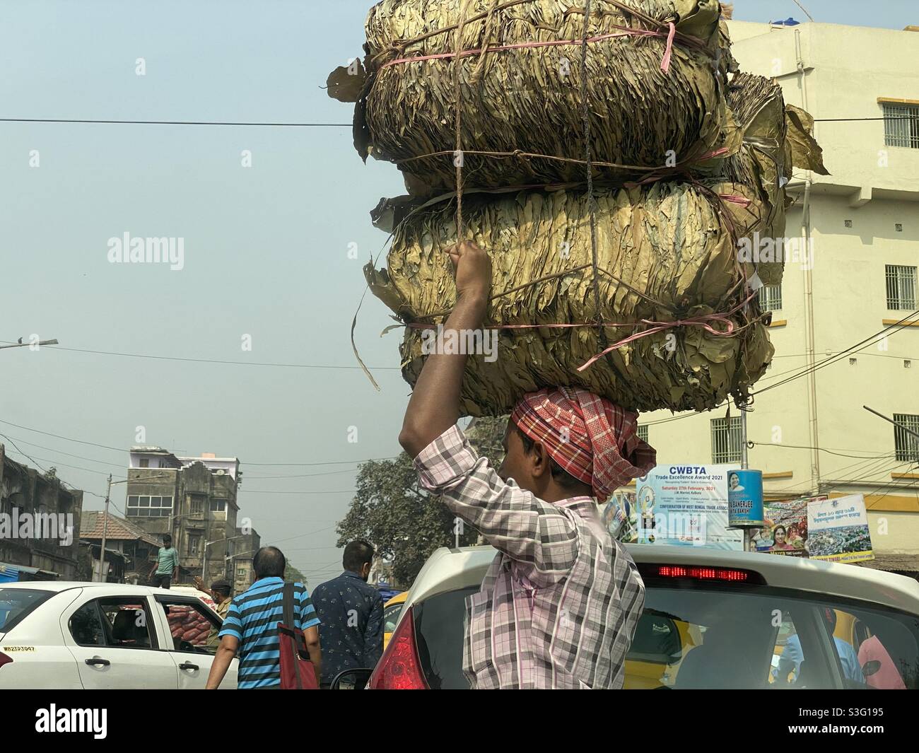 A labour carrying plates made from Sal tree leaves - Smartphone Captured Stock Image
