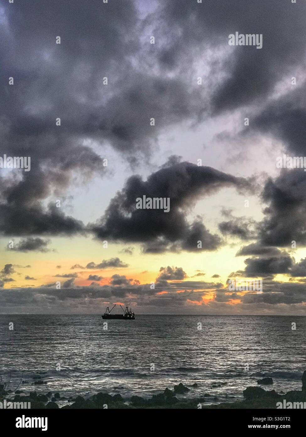 Cargo ship offshore from Easter Island at sunset - Smartphone Captured Stock Image