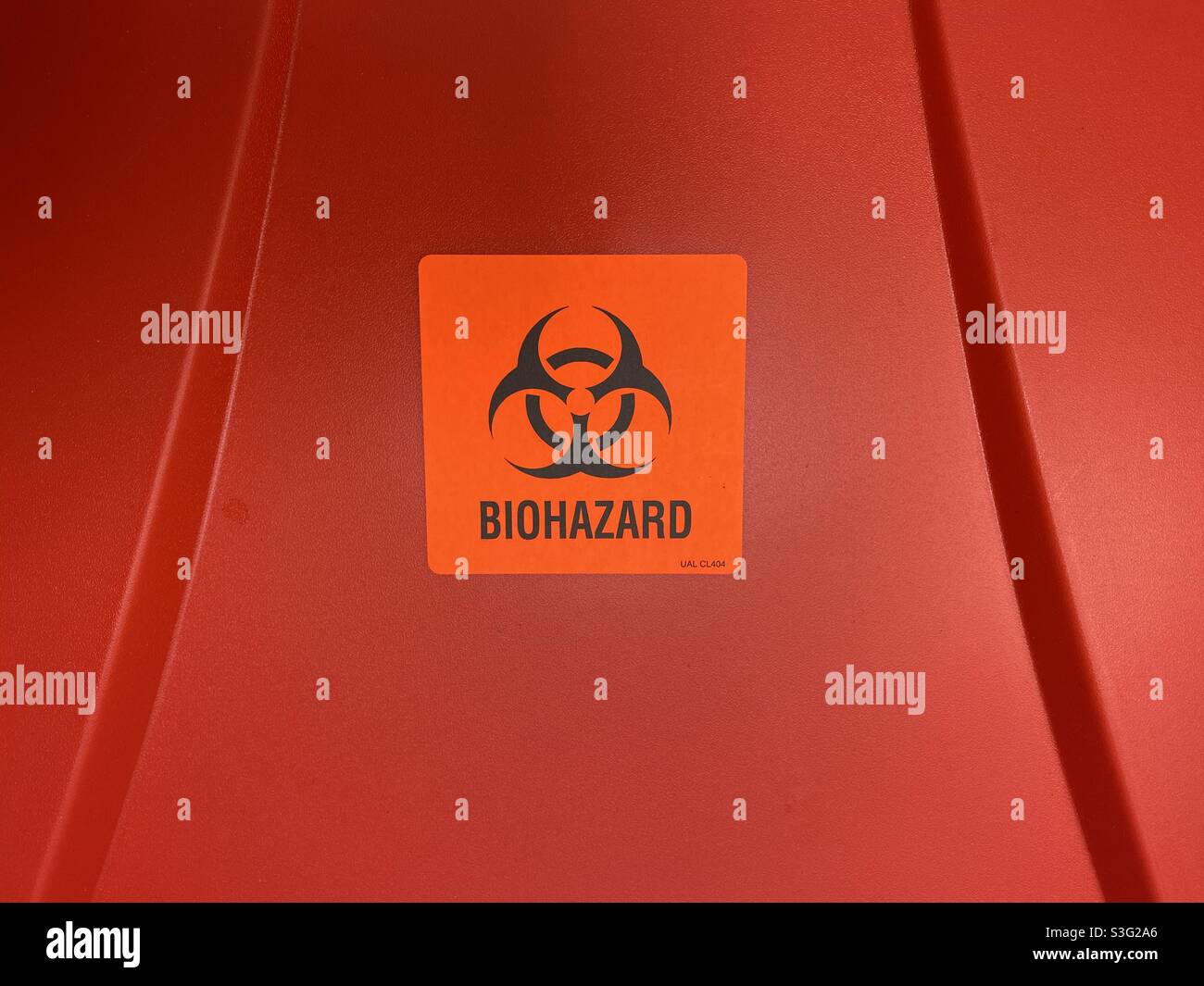 Biohazard label on red bin in hospital. - Smartphone Captured Stock Image