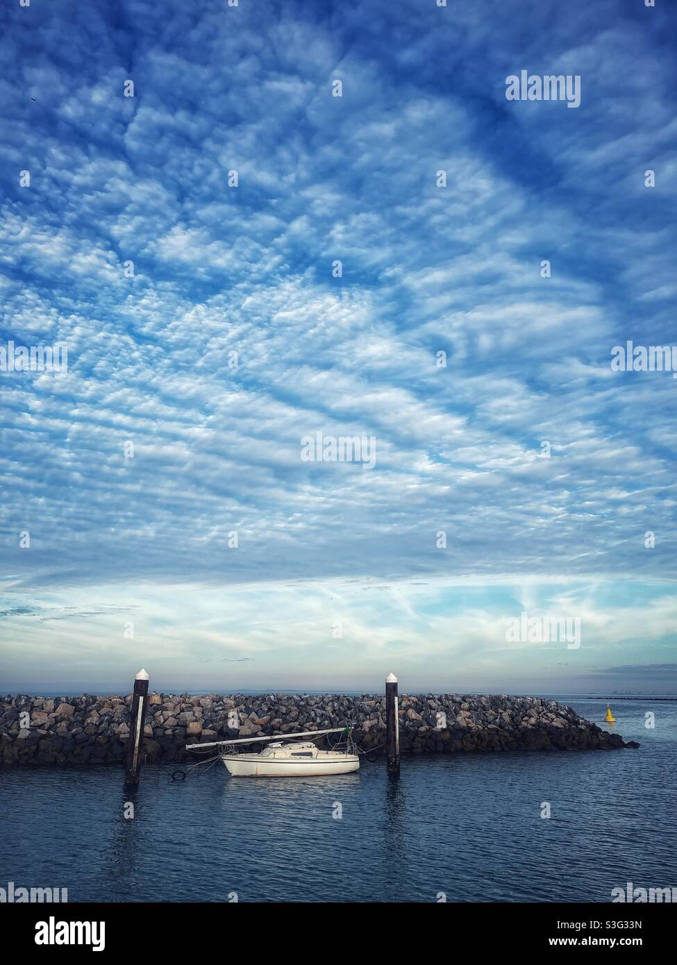 Sailboat with mast down moored in the harbor at Redcliffe, Queensland, Australia - Smartphone Captured Stock Image