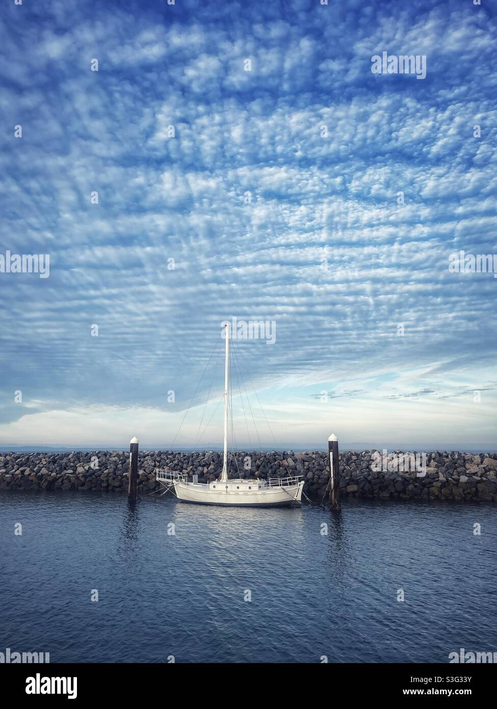 Sailboat in the harbor in Redcliffe, Queensland, Australia under dramatic clouds - Smartphone Captured Stock Image