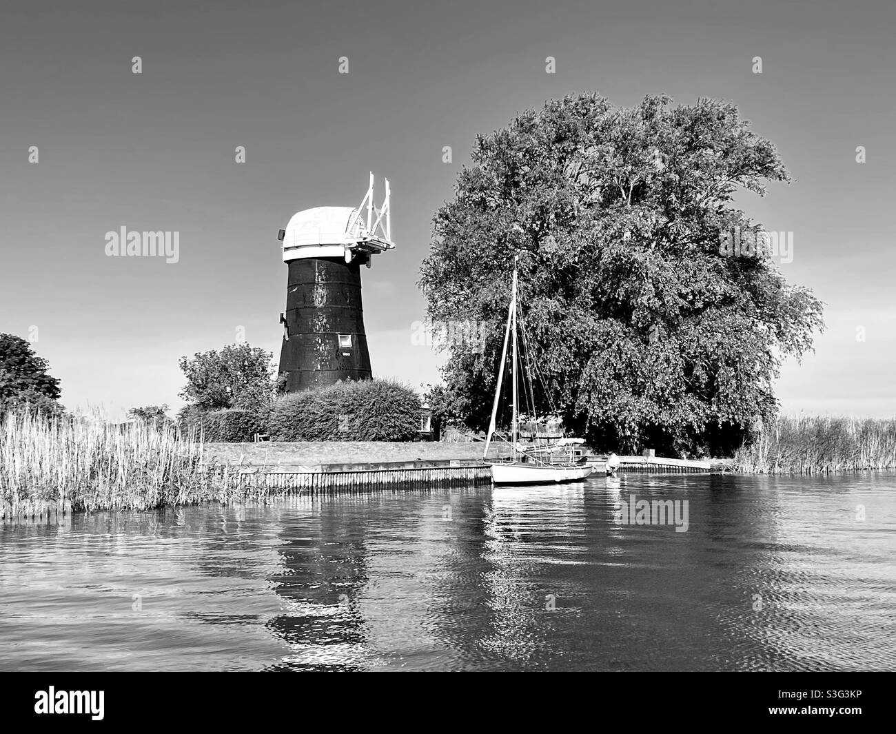 Norfolk Broads, England - sailing boat, river, windmill Stock Photo
