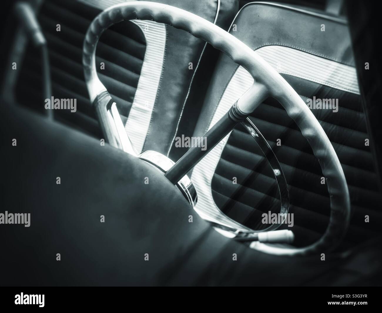 Classic car steering wheel and front seat in black and white - Smartphone Captured Stock Image