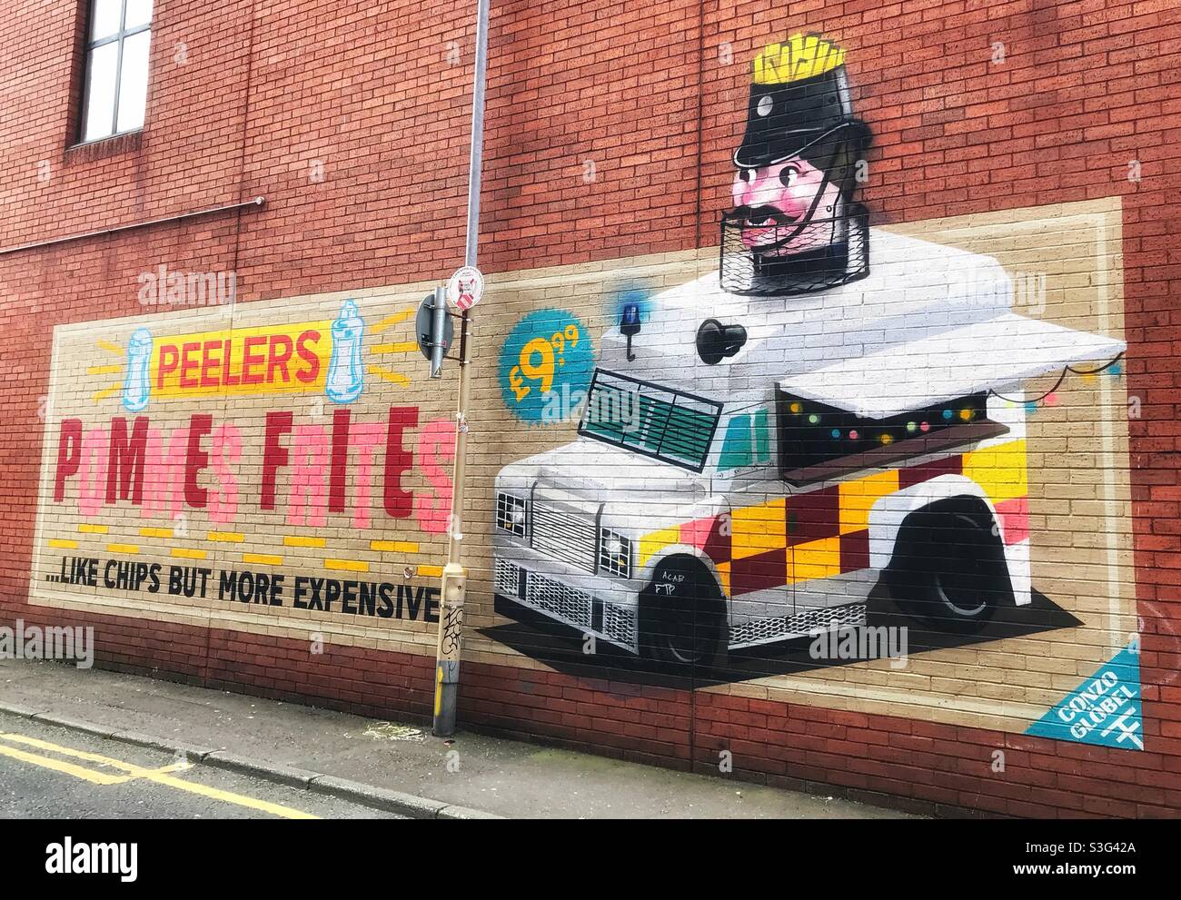 Street Art in Belfast Northern Ireland- Pomme Frites by Peelers featuring a  police Van with Policeman Stock Photo - Alamy