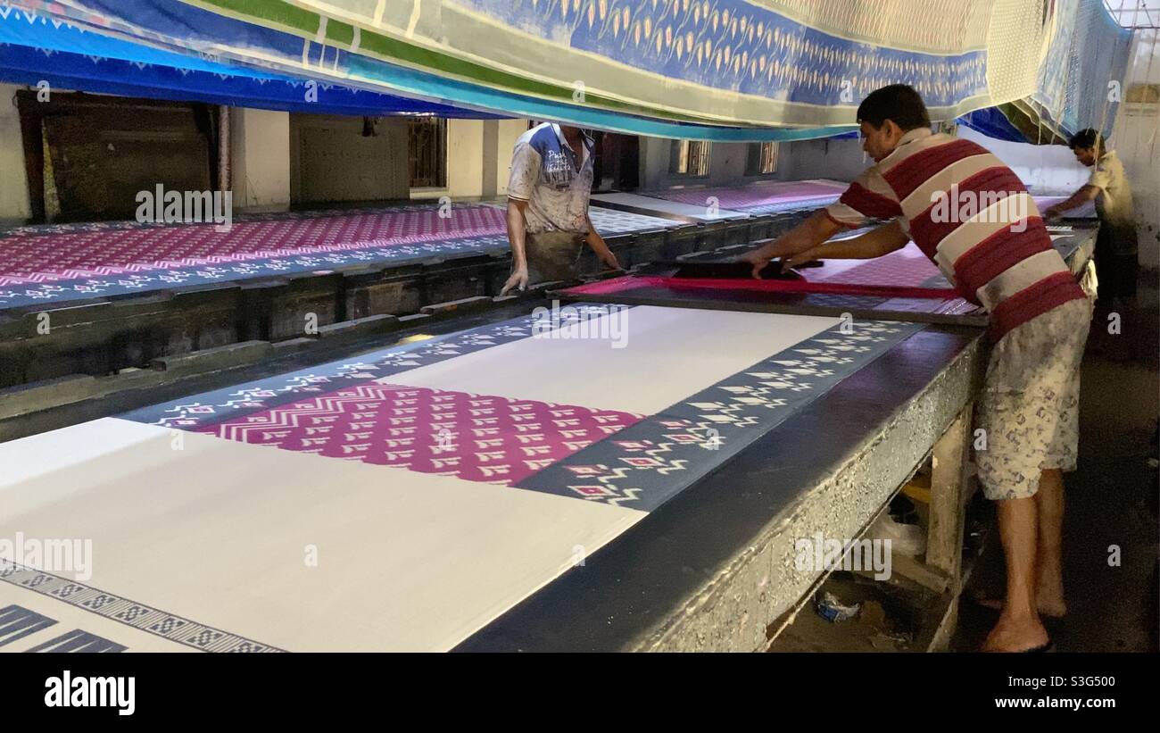 Color painted on Indian traditional sari in a factory - Smartphone Captured Stock Image