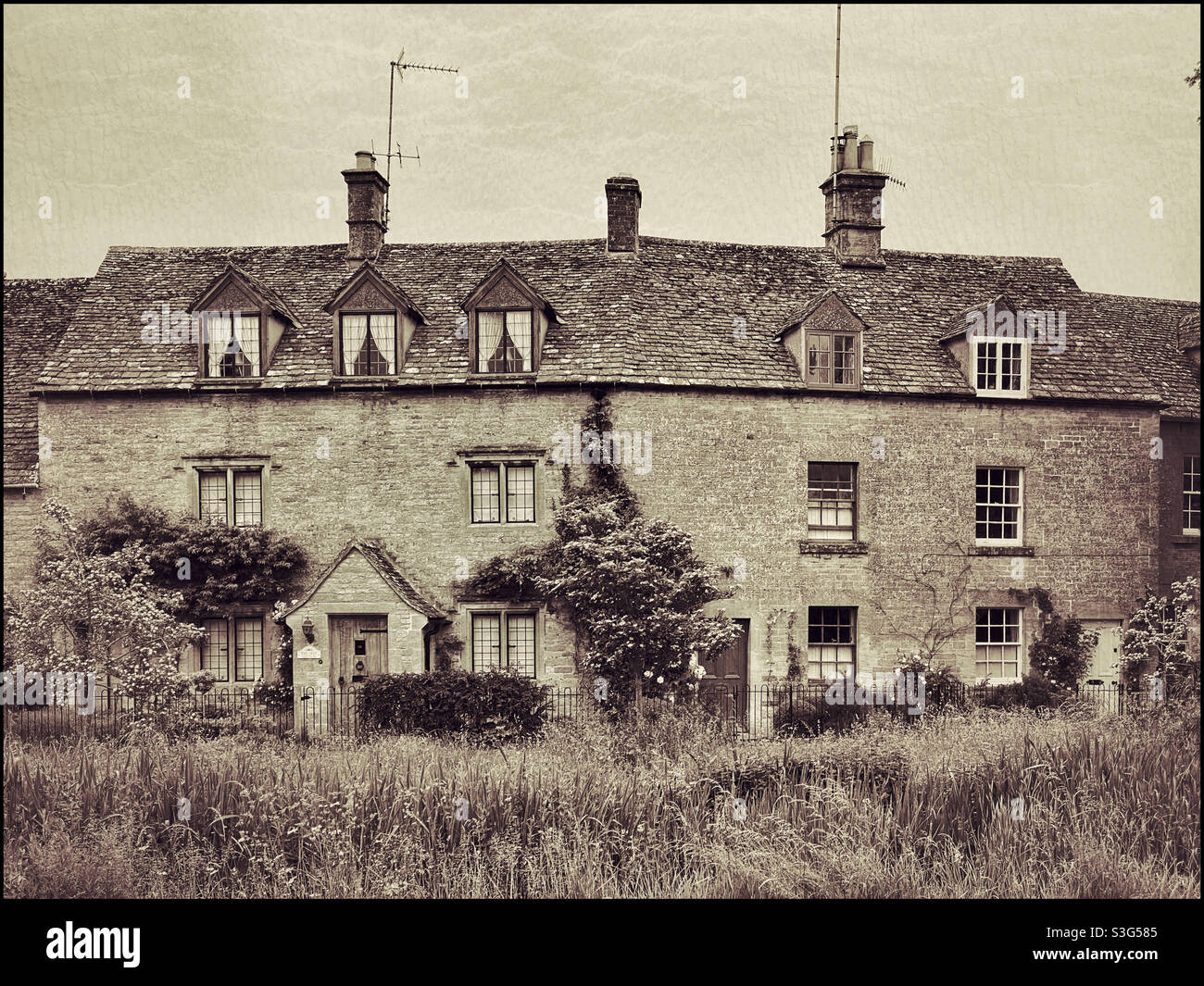 A group of houses in the English Cotswold village of Lower Slaughter. A classic example of a Cotswold Stone house. Photo ©️ COLIN HOSKINS. - Smartphone Captured Stock Image