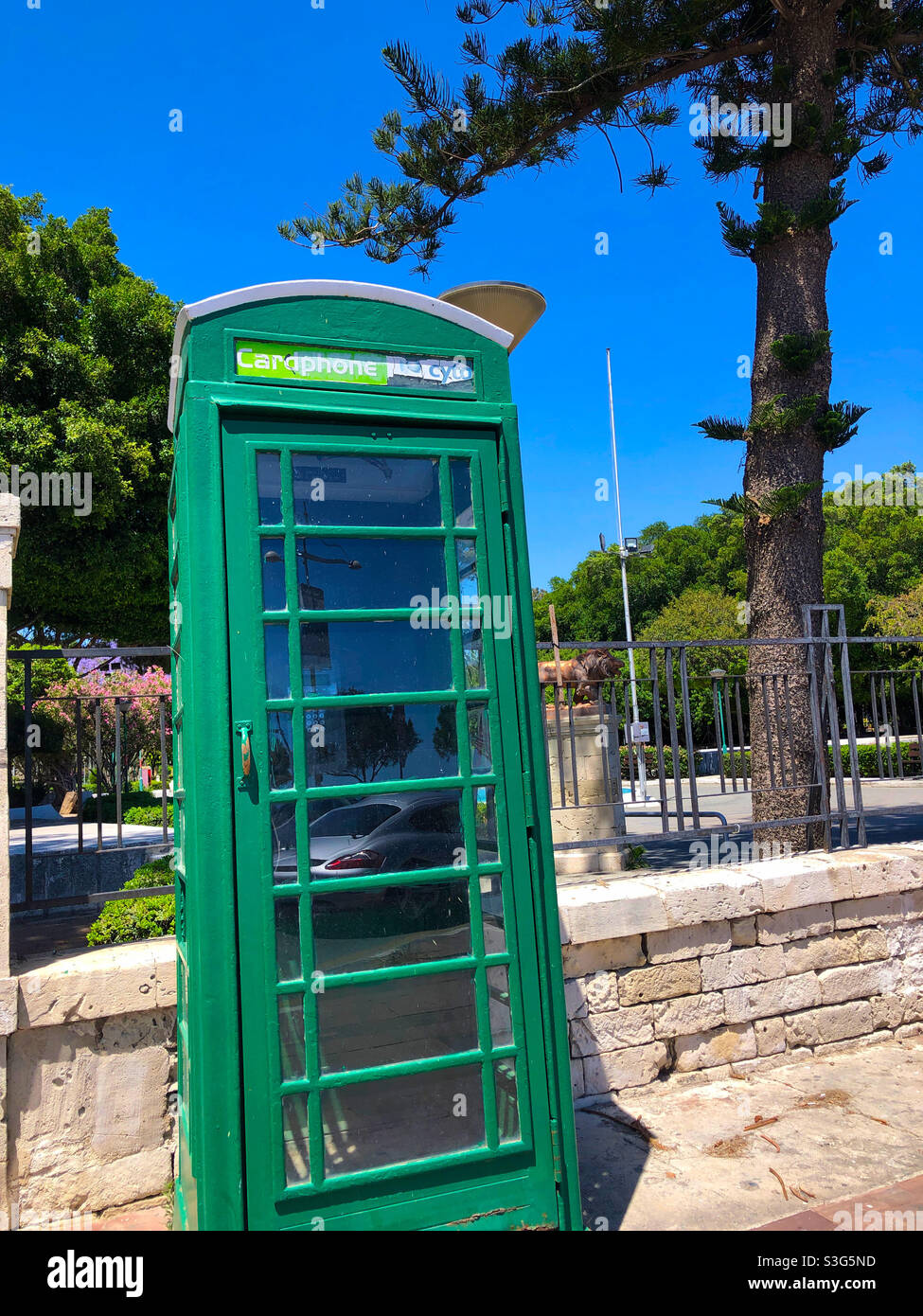 A former British phone box painted green in Limassol, Cyprus Stock Photo