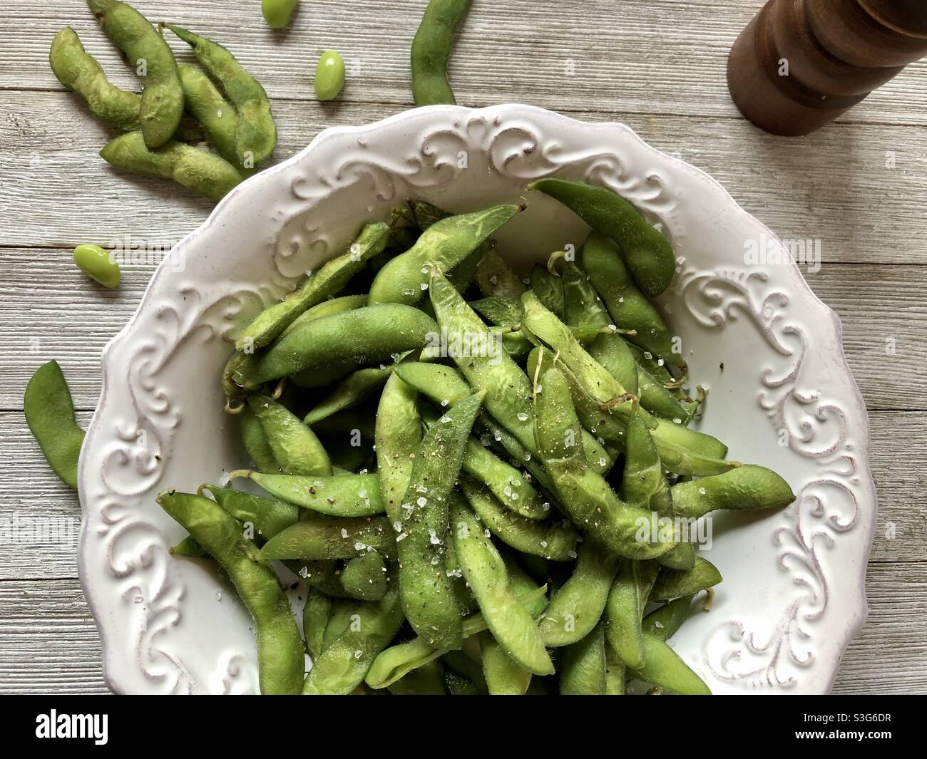 Edamame in a decorative white bowl, top view Stock Photo