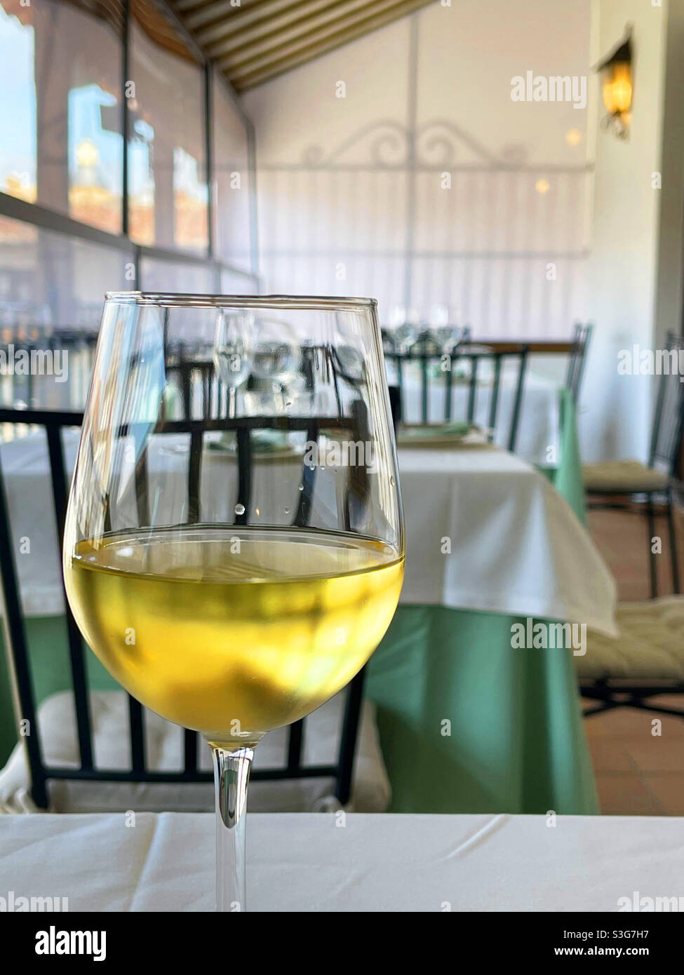 Glass of white wine in a restaurant. - Smartphone Captured Stock Image
