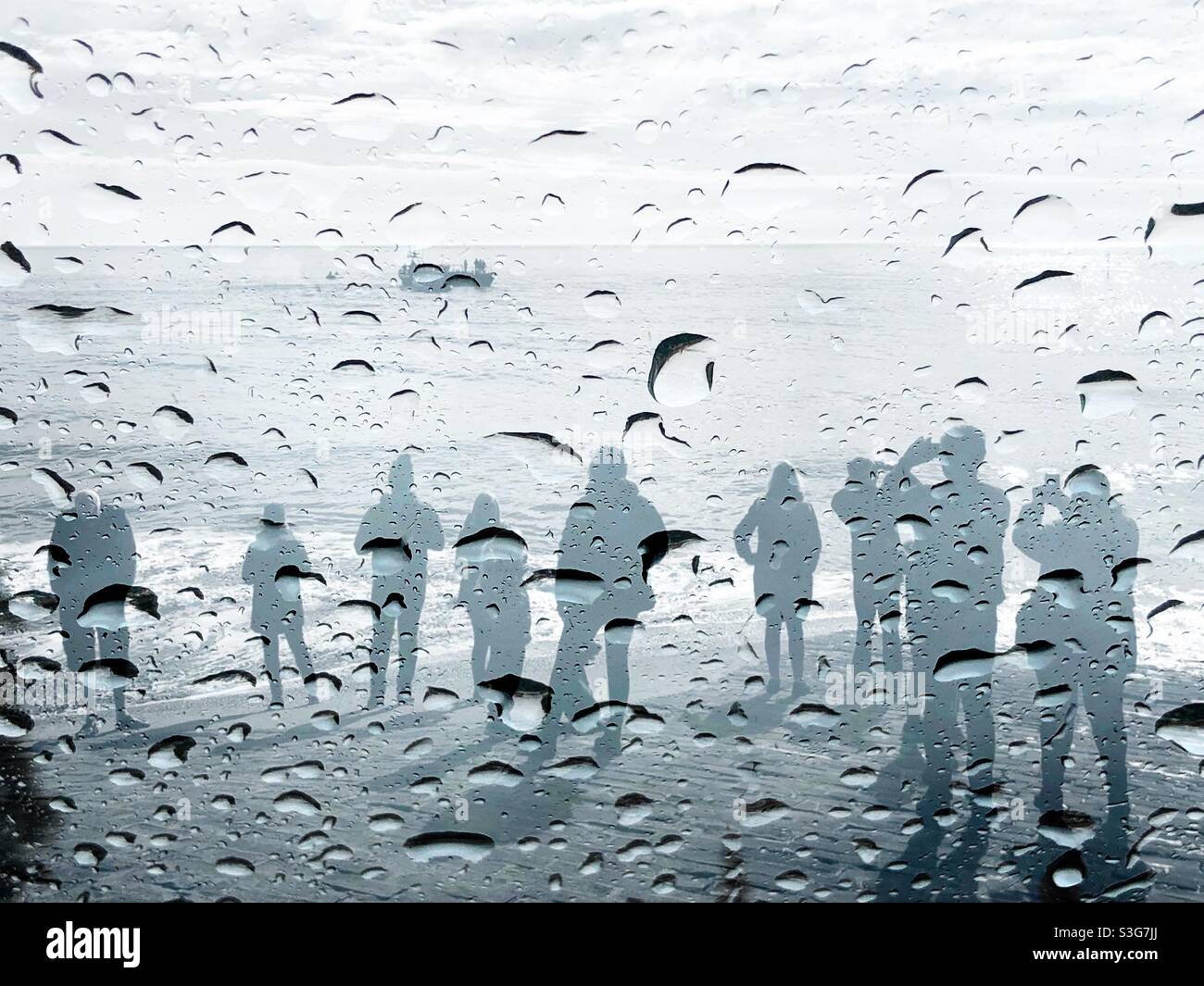 Double exposure - rain on glass, people watching a boat - Smartphone Captured Stock Image