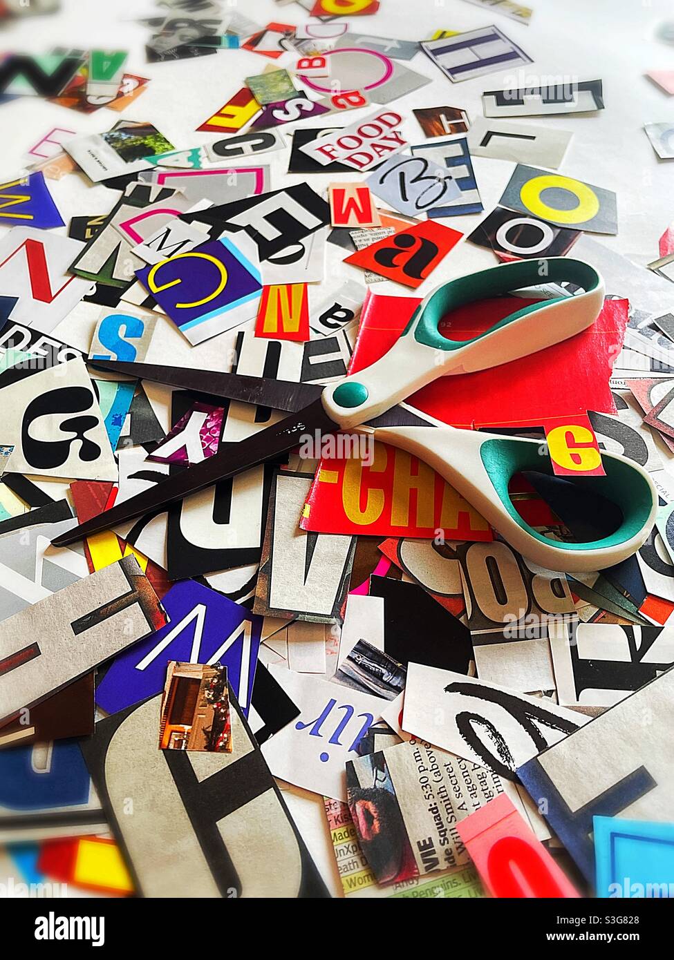 Scissors on a flat surface covered with cut out letters, USA - Smartphone Captured Stock Image