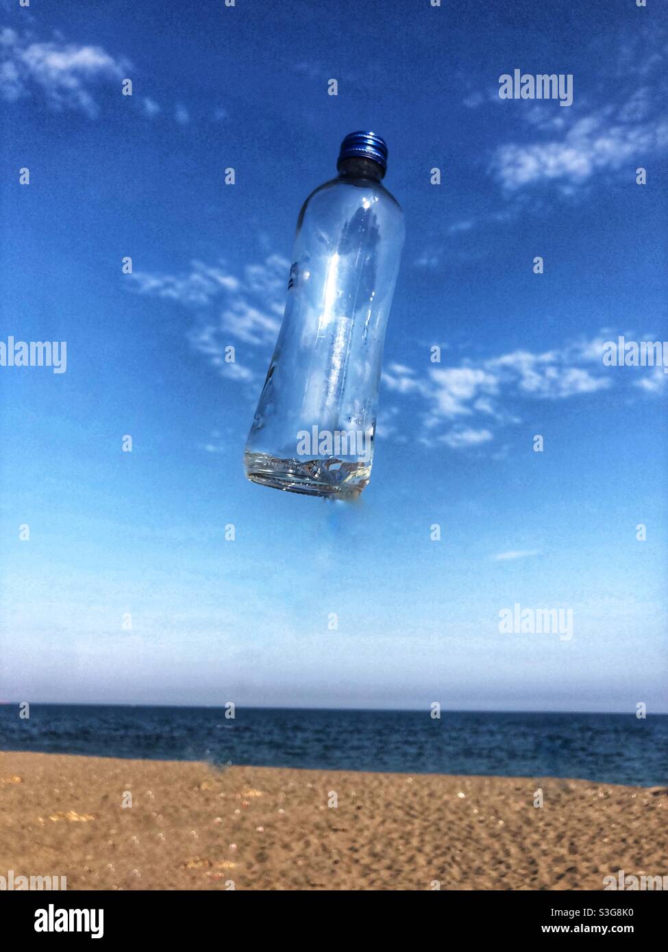 Clear bottle in midair Stock Photo