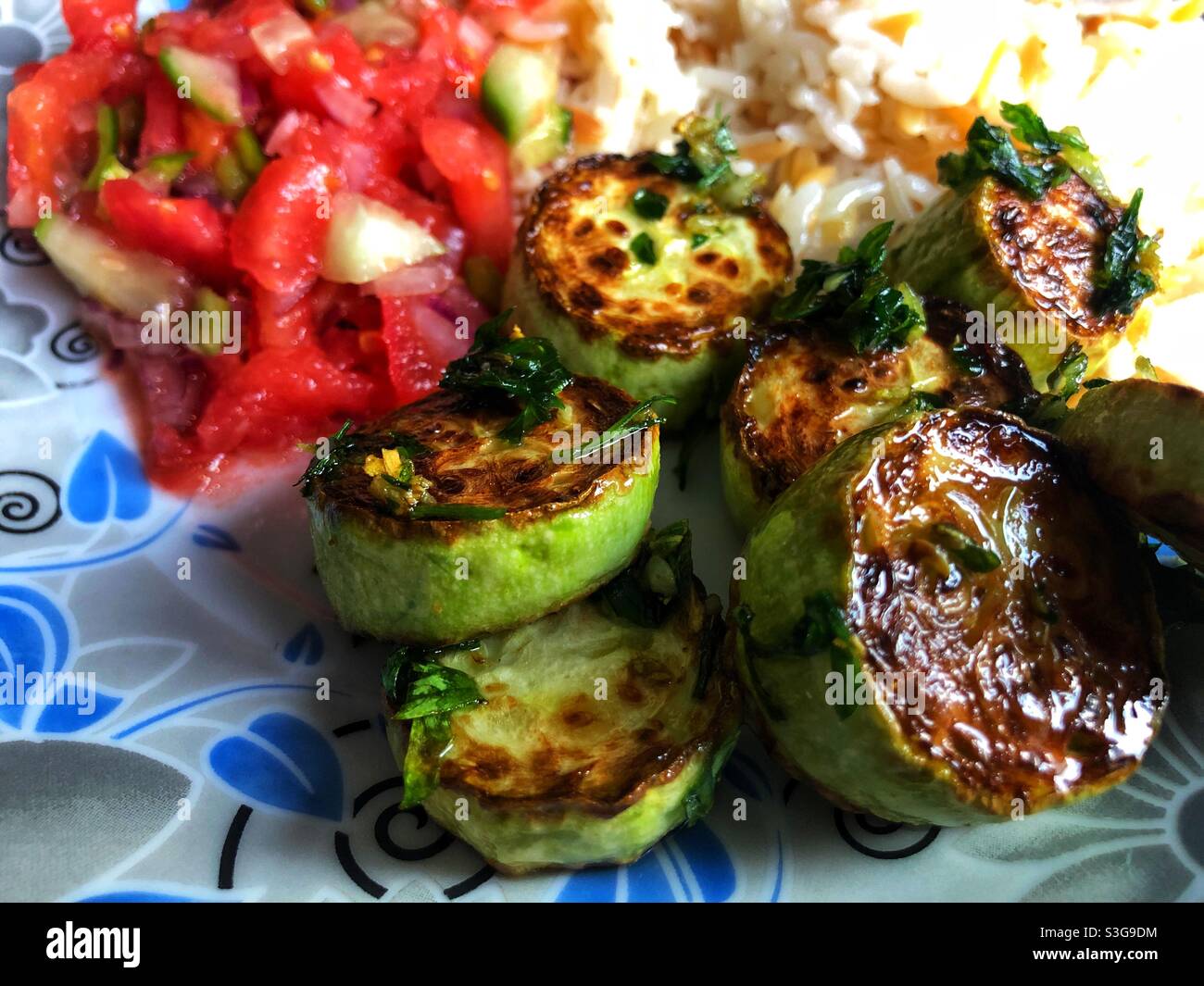 Spanish style fried garlic zucchini served with rice and salad - Smartphone Captured Stock Image Spanish style fried garlic zucchini served with rice and salad - Smartphone Captured Stock Image