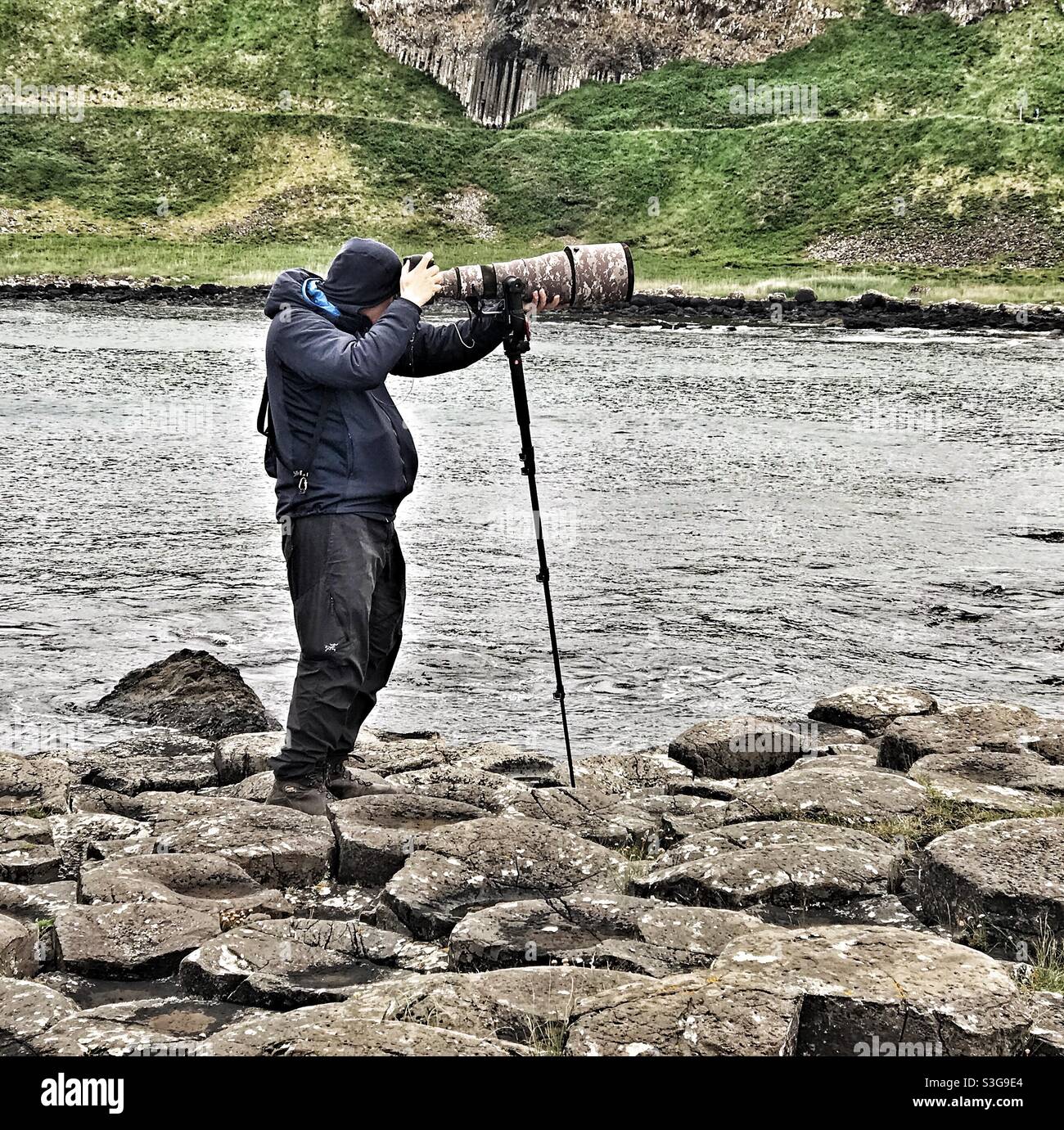Photographer at Giants Causeway in Northern Ireland - Smartphone Captured Stock Image