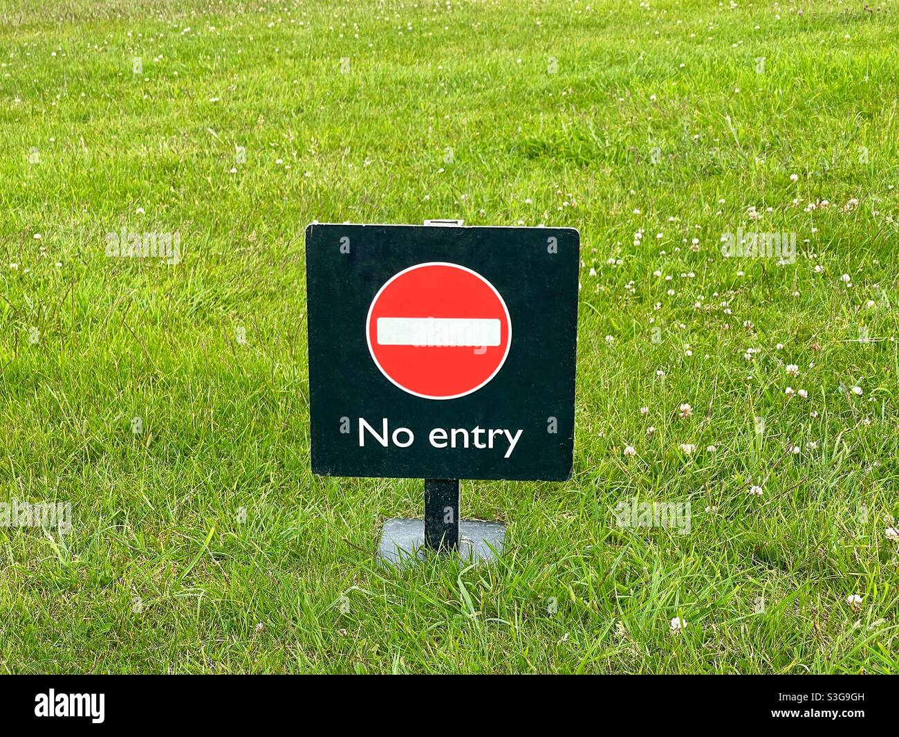 No entry sign on a plain background of green grass Stock Photo