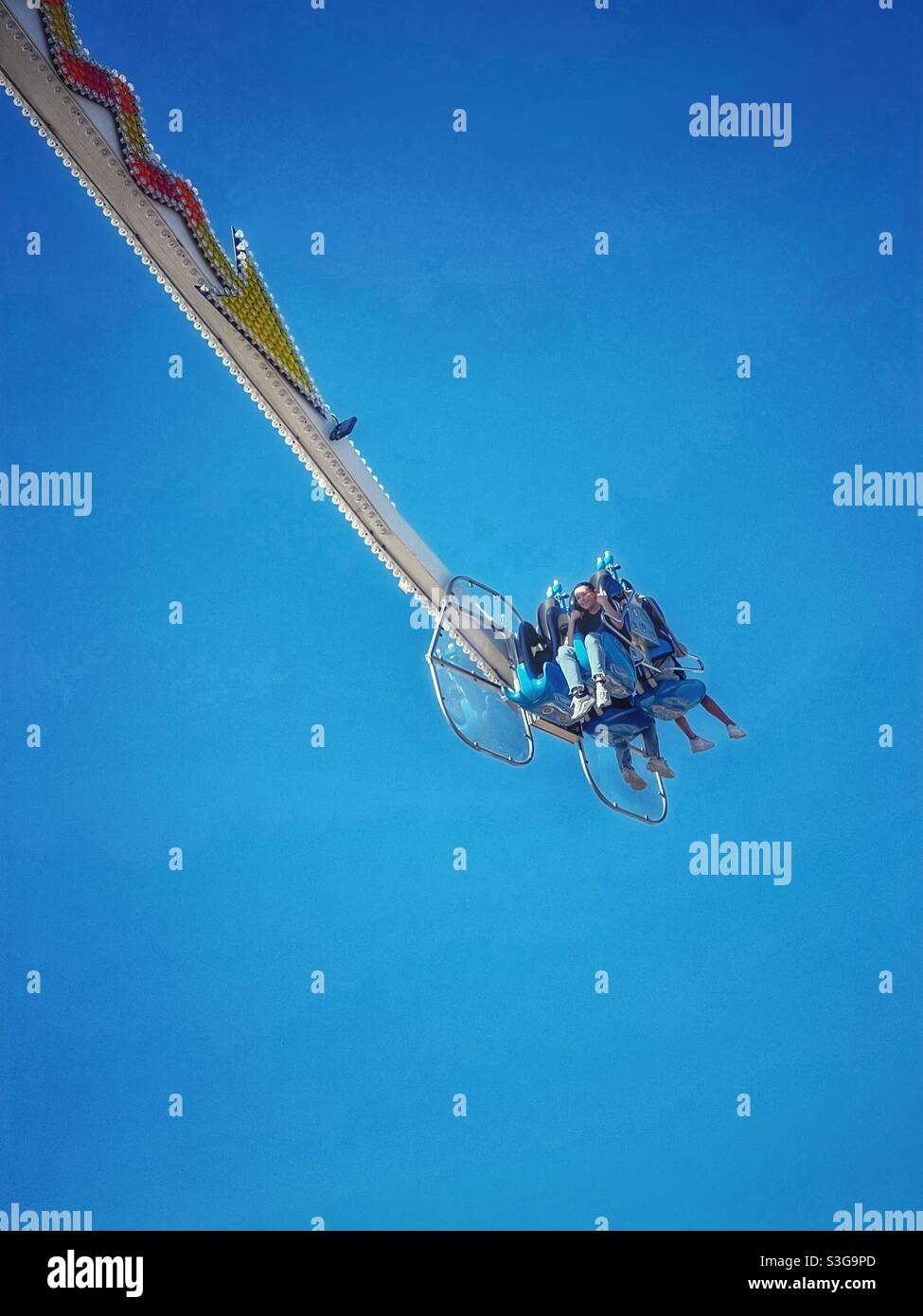 Teenagers enjoy a carnival ride - Smartphone Captured Stock Image