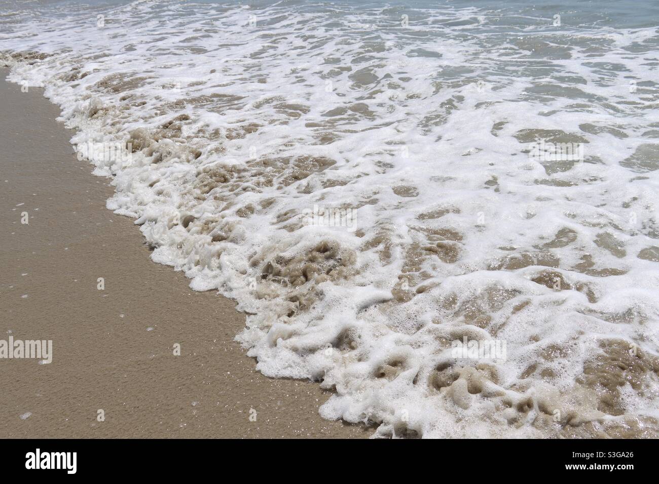 Waves and foam at the beach in Brittany - Smartphone Captured Stock Image