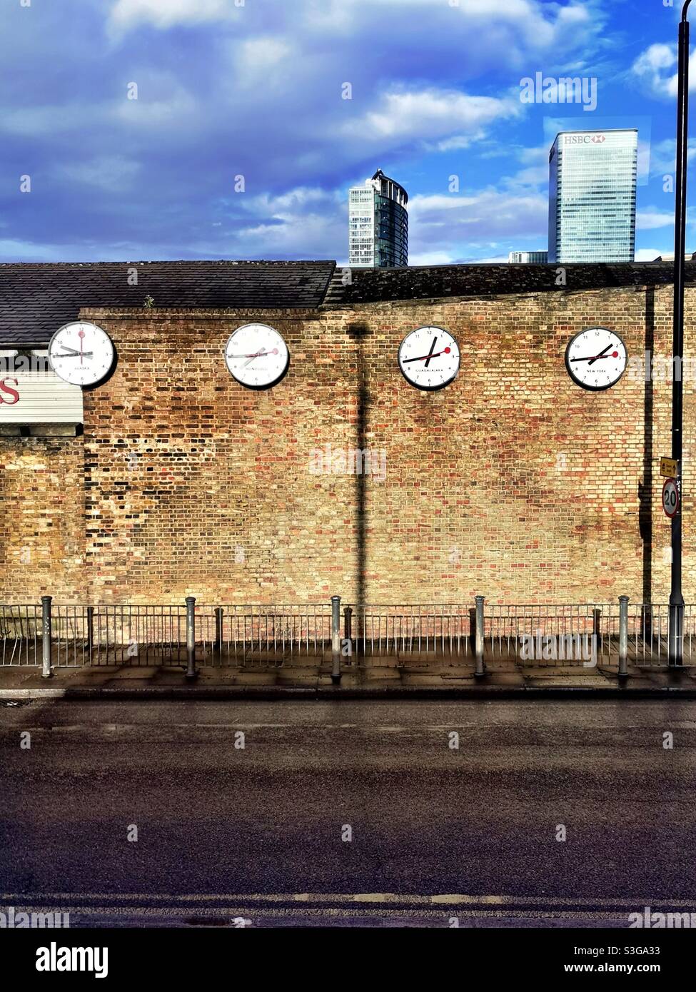 world clocks on brick wall Stock Photo Alamy