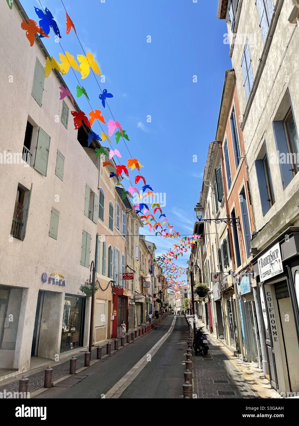 Main Street of Martigues, near Marseille, Bouches-du-Rhône, Provence-Alpes-Côte d'Azur, south of France, with butterflies decoration - Smartphone Captured Stock Image