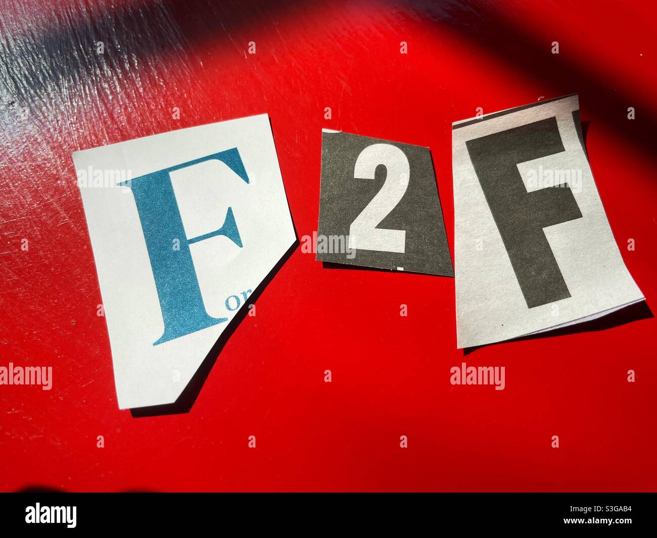 Ransom note style spelling out face to face, USA - Smartphone Captured Stock Image