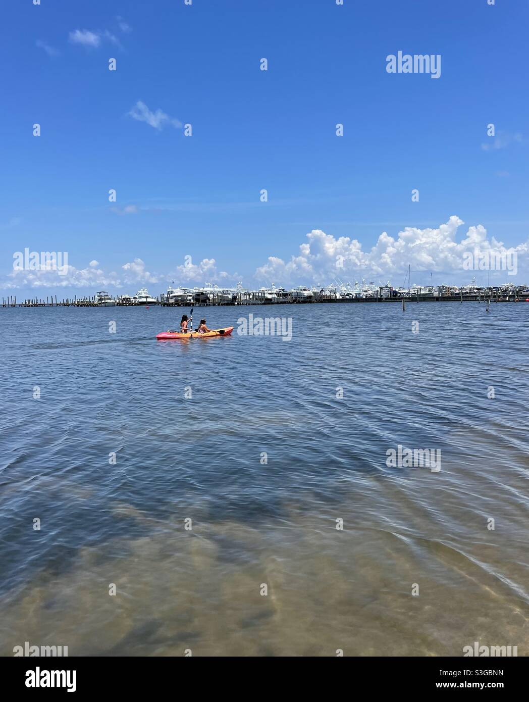 Canoeing across a boat marina Stock Photo