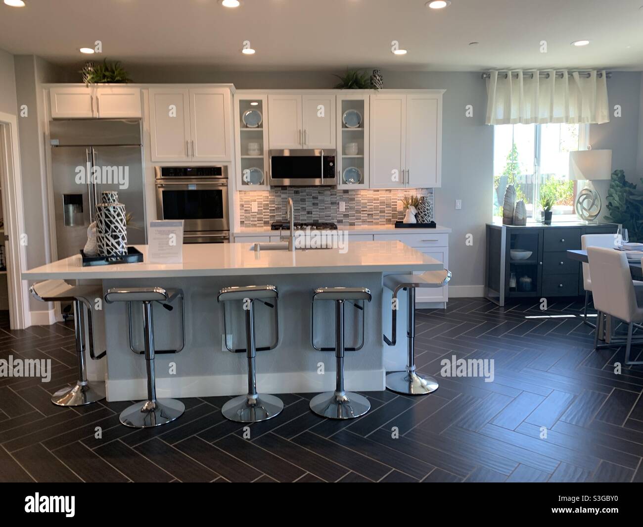 Modern farmhouse kitchen with quartz marbled countertops and white