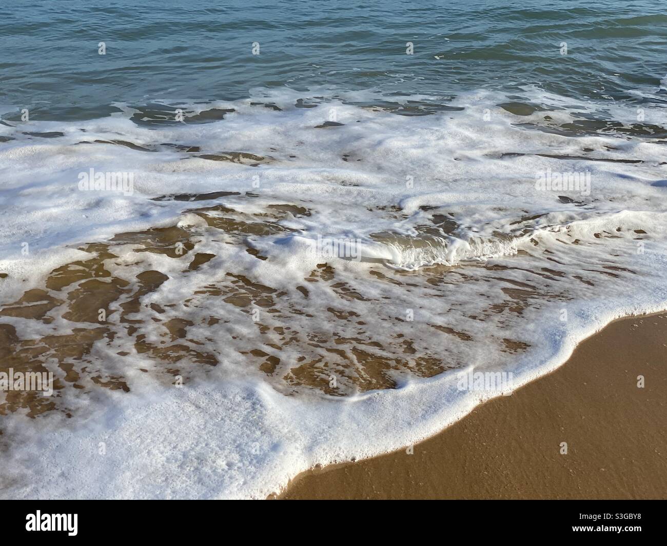 Waves lapping the sea shore Stock Photo