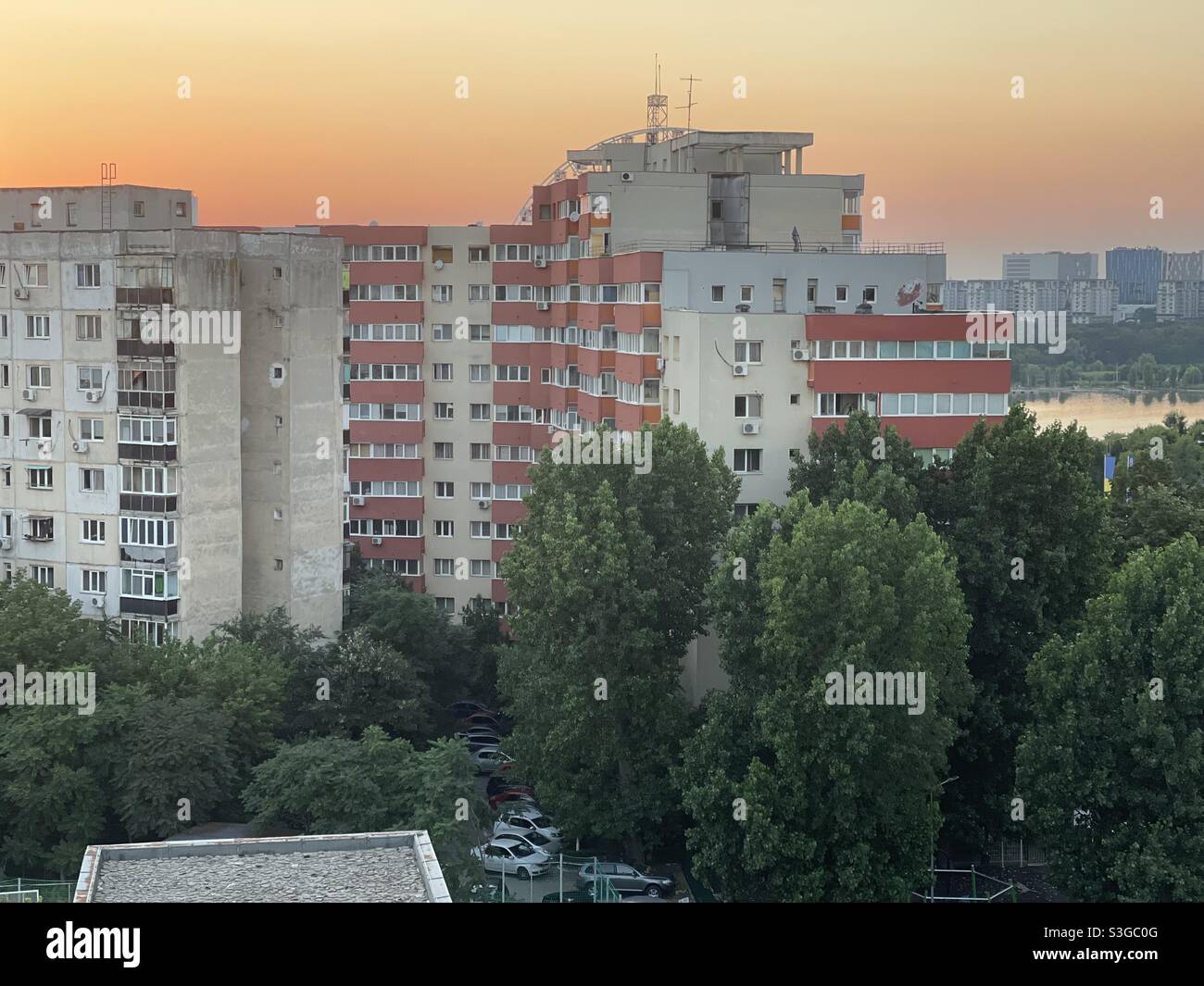 Sunset over communism era architecture buildings, Tei lake zone, Bucharest, Romania - Smartphone Captured Stock Image