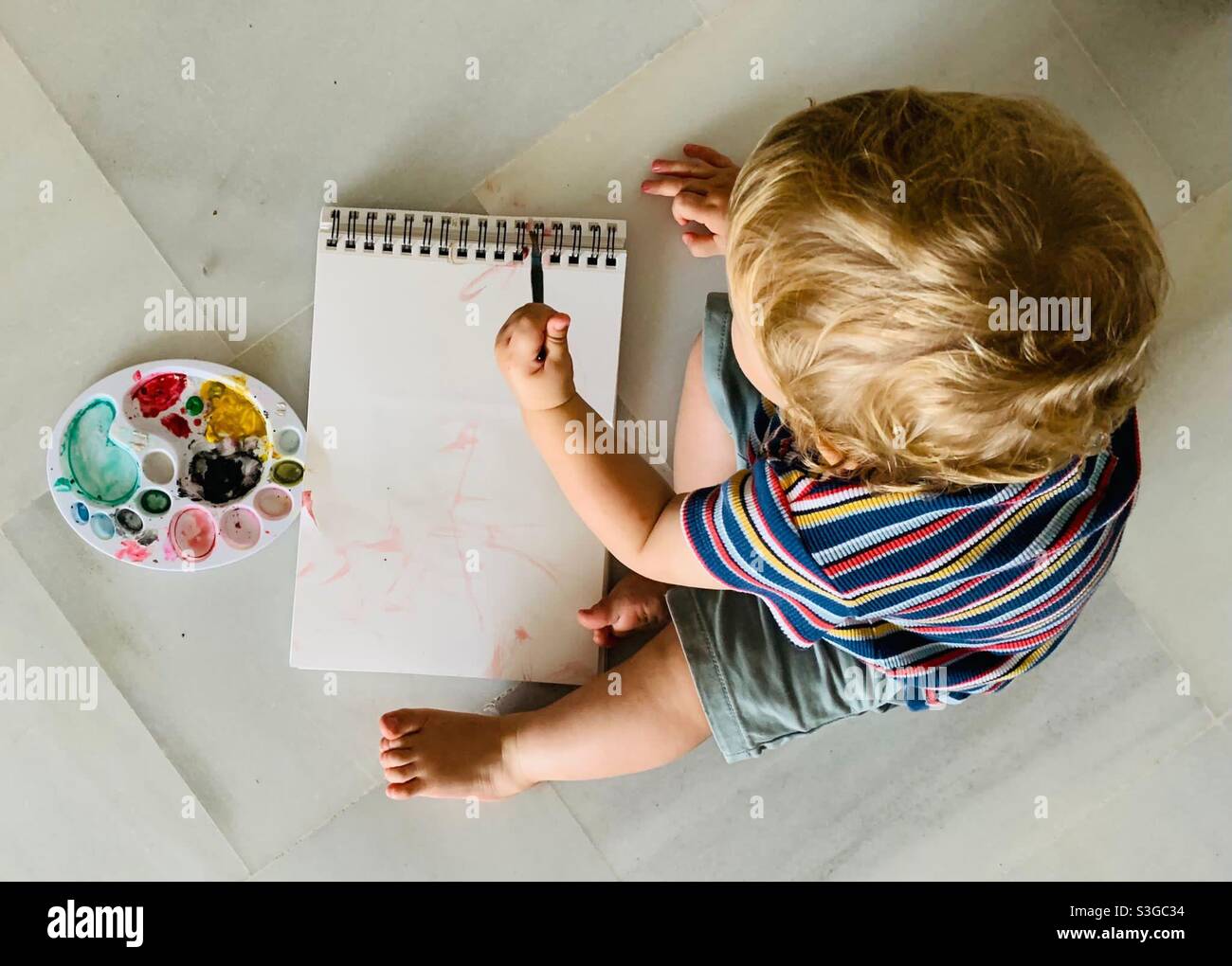 One year old toddler learning to paint - Smartphone Captured Stock Image