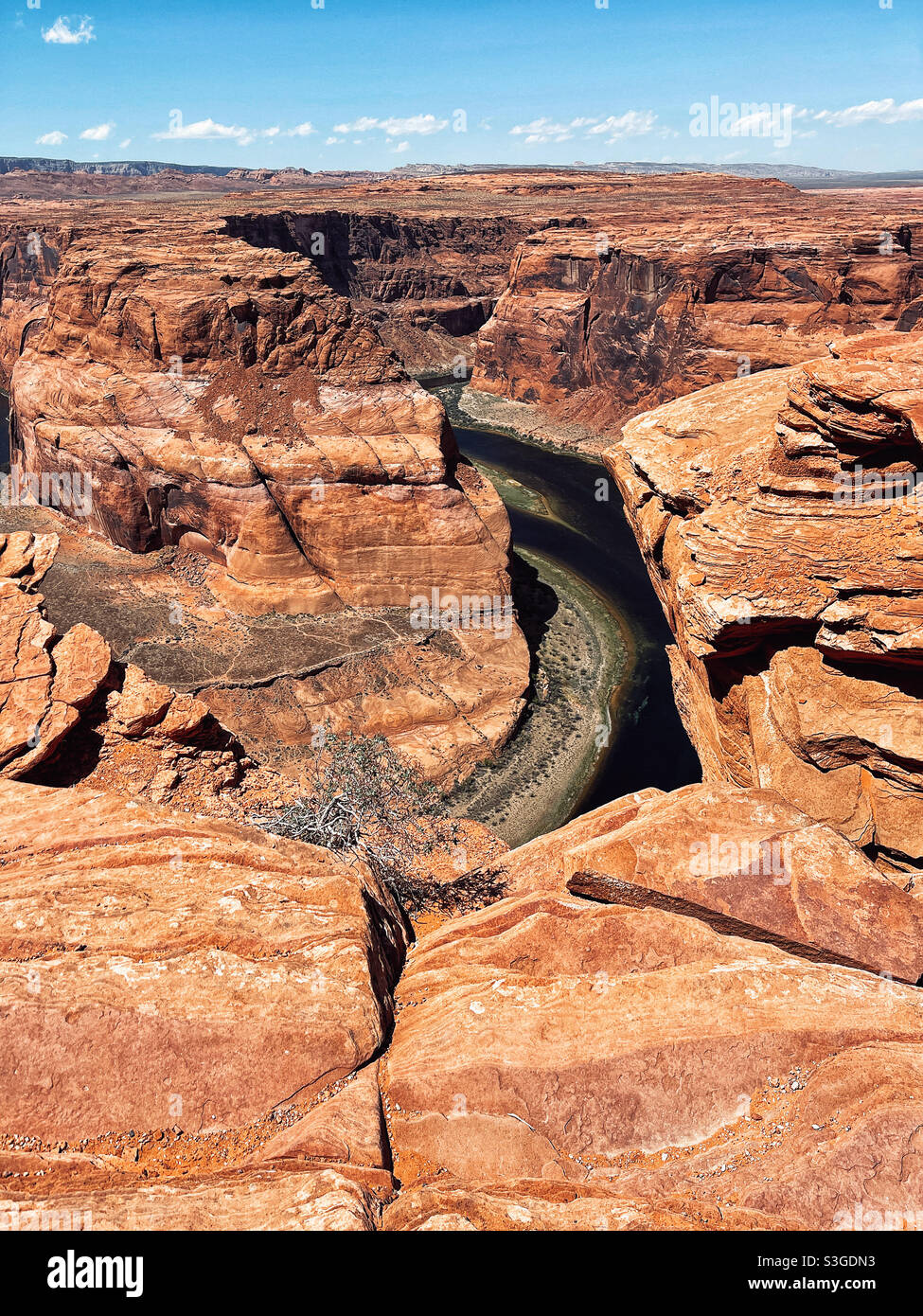 Colorado river snakes at the bottom of deep canyon in Horseshoe bend natural area in Arizona - Smartphone Captured Stock Image