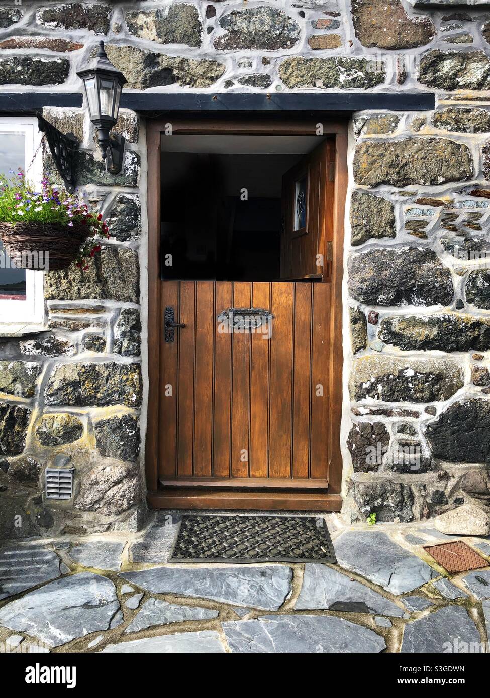 A half open stable door to a beautiful and traditional stone cottage - Smartphone Captured Stock Image