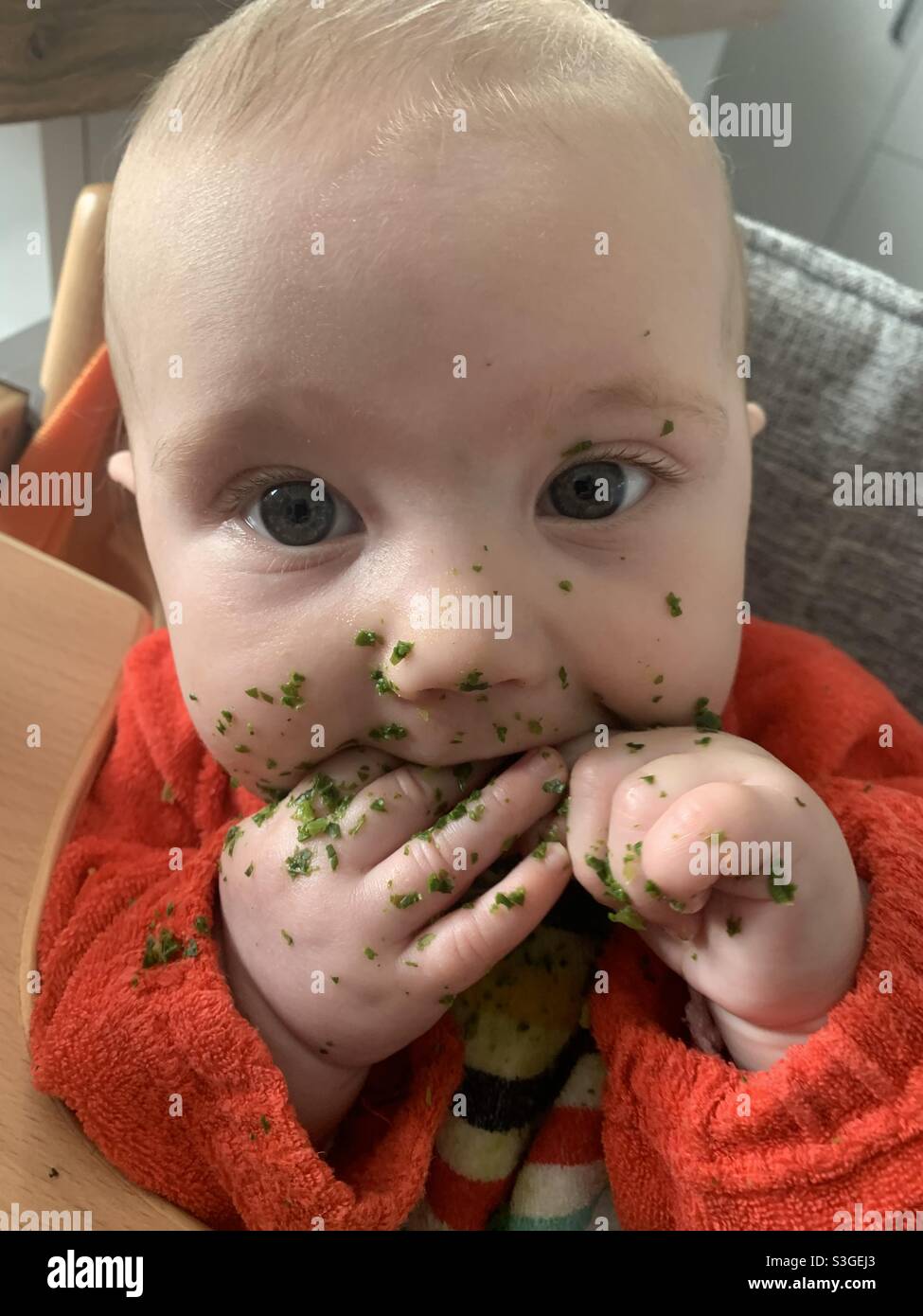 Hungry and messy baby Stock Photo