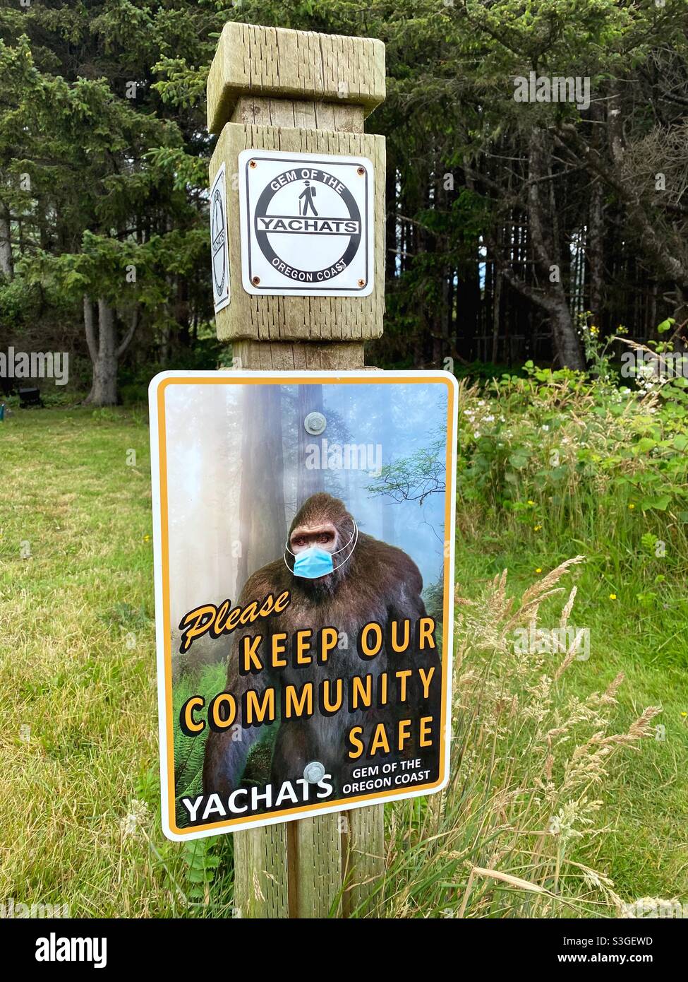 A funny sign depicting bigfoot wearing a face mask, in Yachats, Oregon. Stock Photo
