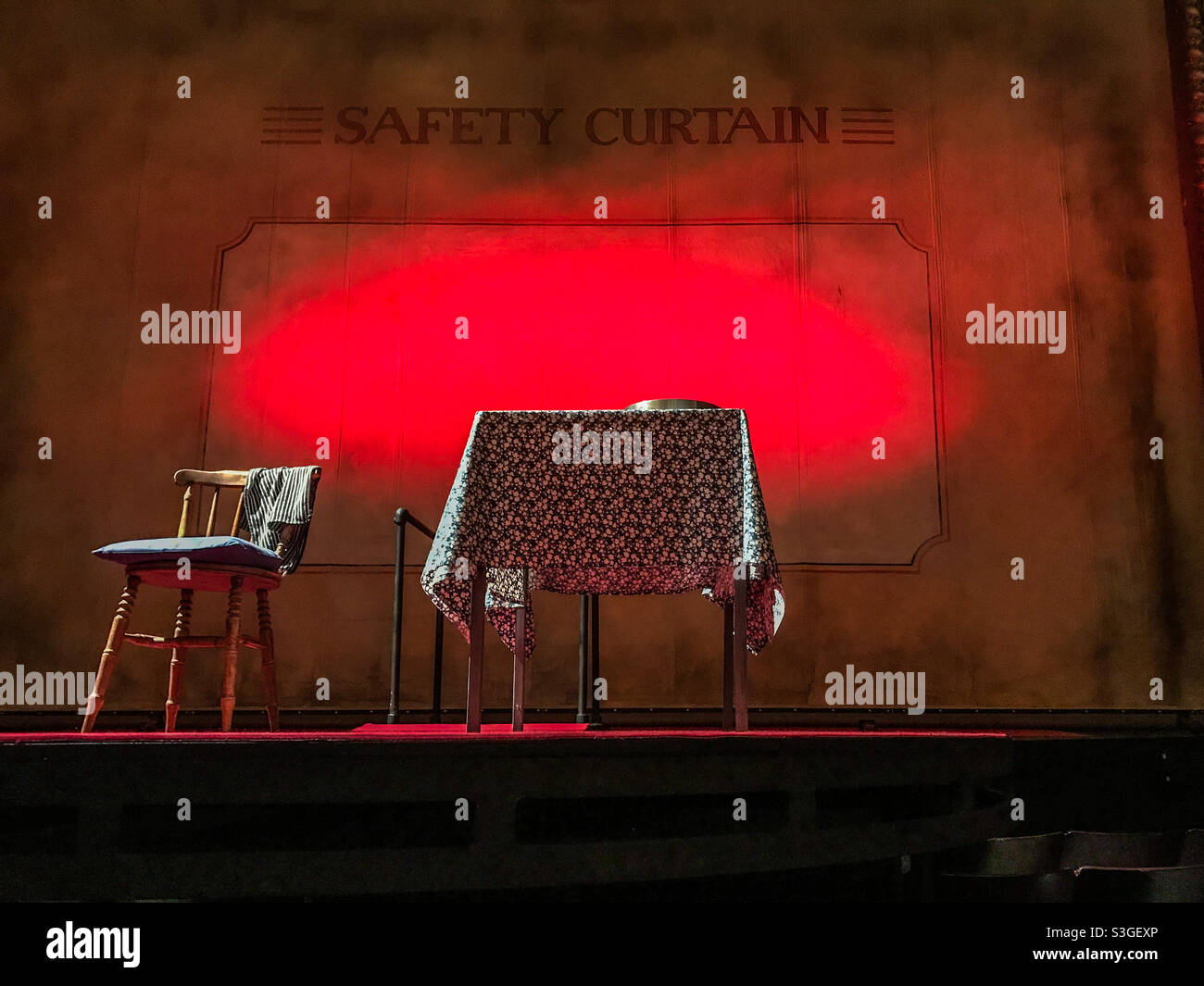 Table and chair on a theatre stage - Smartphone Captured Stock Image