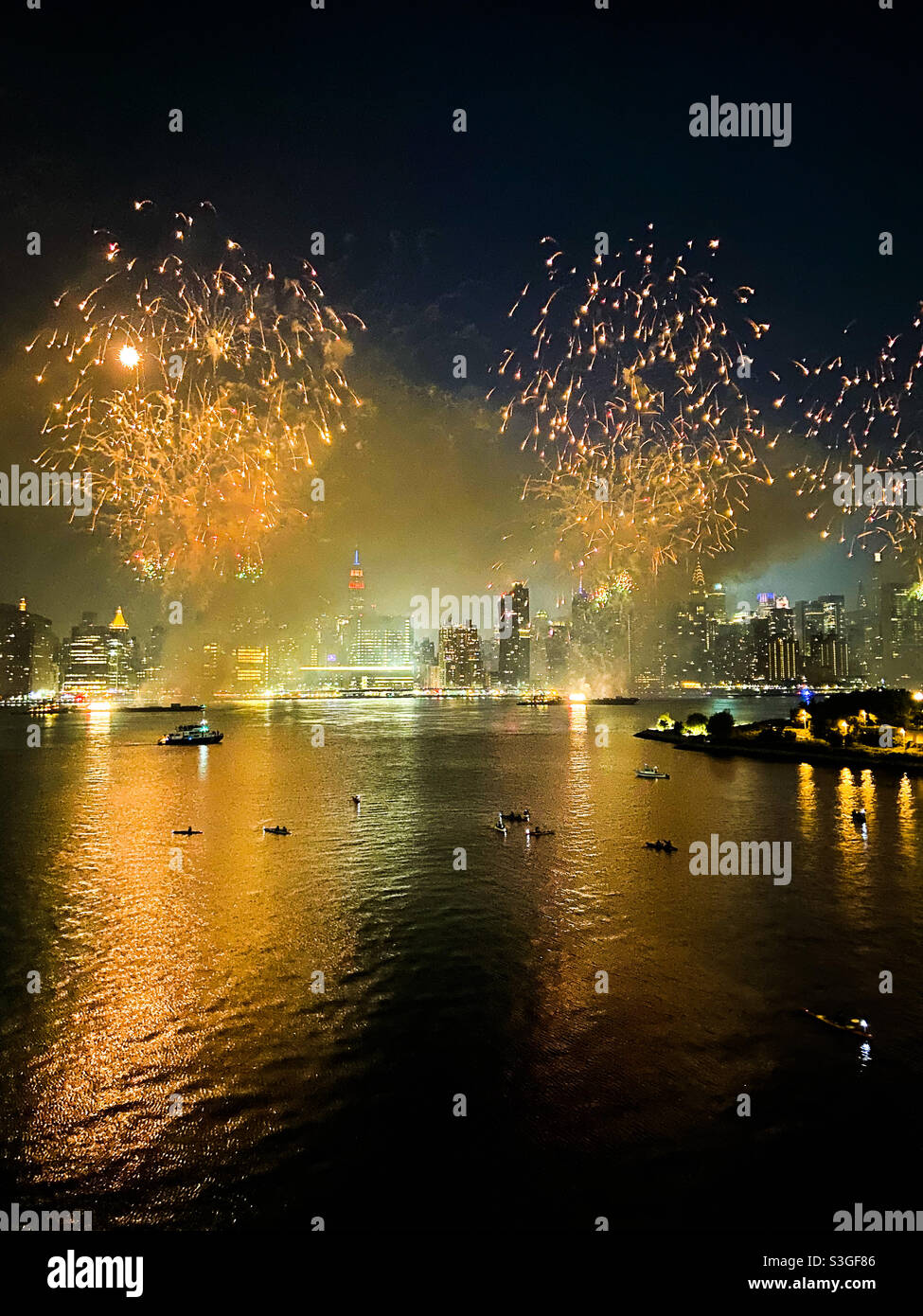 Kayakers watch fireworks over the East River in New York City on July 4, 2021. - Smartphone Captured Stock Image