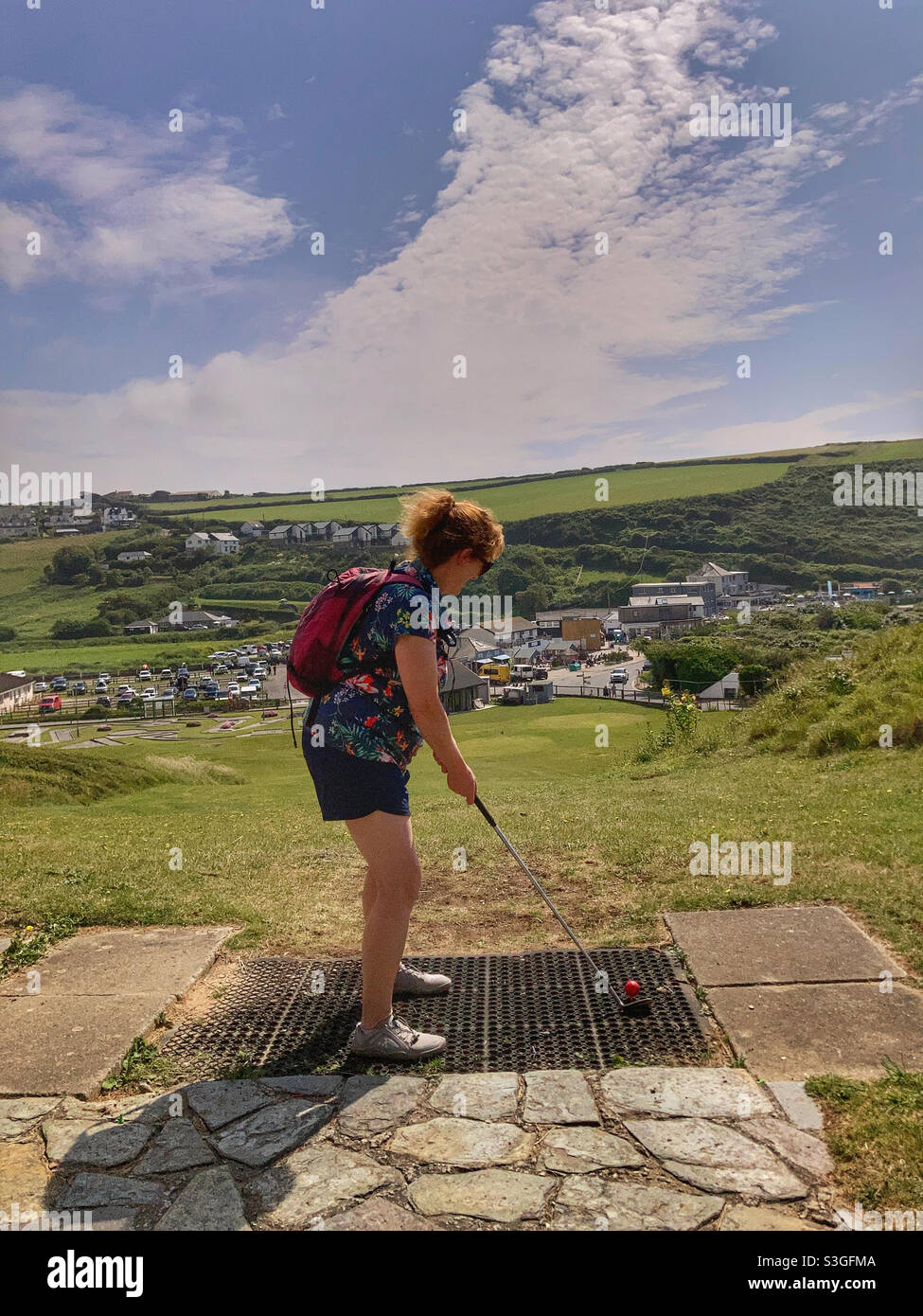Woman playing pitch and putt golf Mawgan Porth Cornwall - Smartphone Captured Stock Image