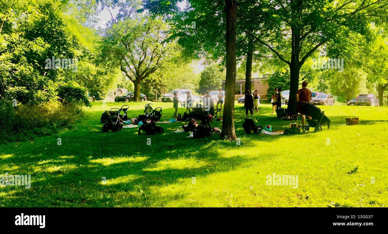 New moms, babies, and prams, an exercise group in a park, Ontario, Canada. A happy place. Stock Photo