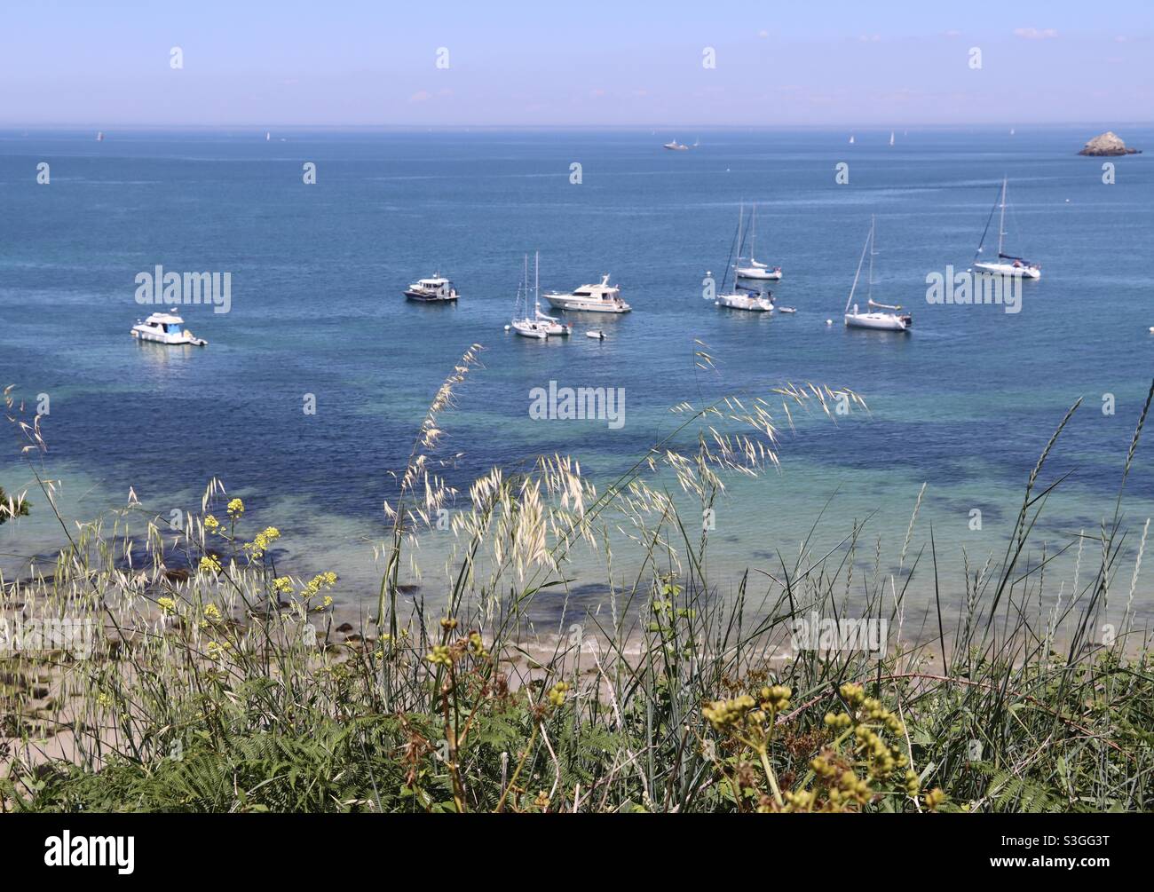View on some sailboats at the paradise island of Houat in Brittany, Morbihan, France - Smartphone Captured Stock Image