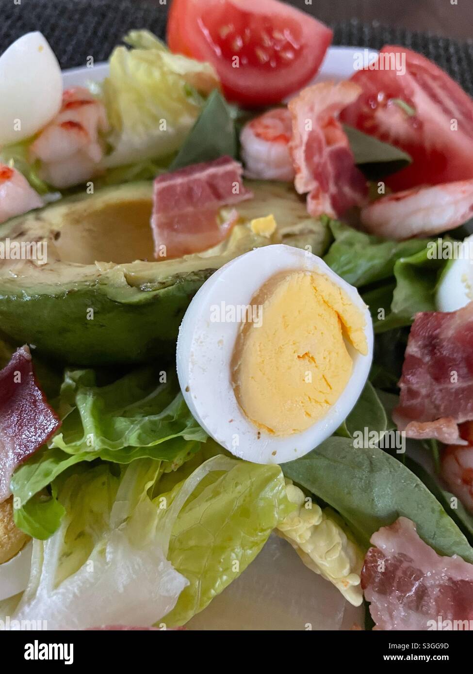 Close up of a freshly made Cobb salad featuring hard-boiled eggs, avocados and bacon - Smartphone Captured Stock Image